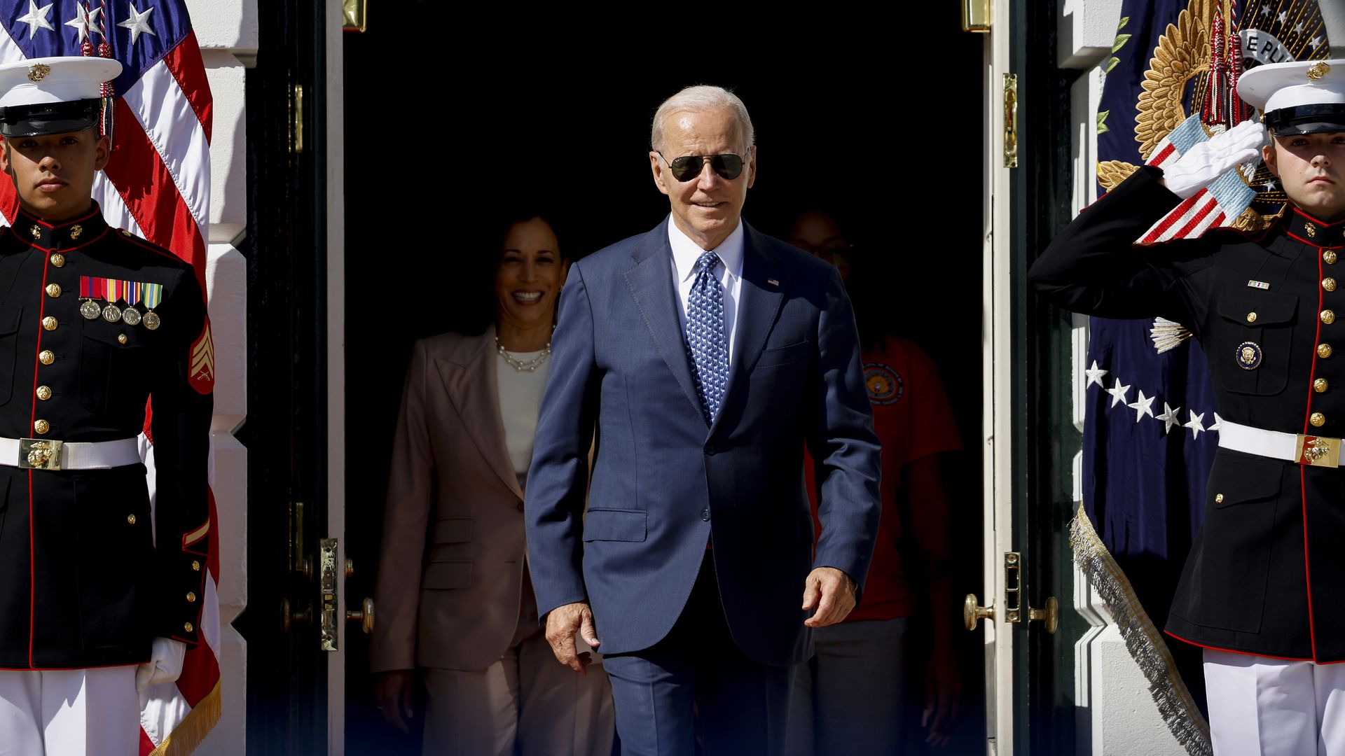 President Joe Biden walking through a door
