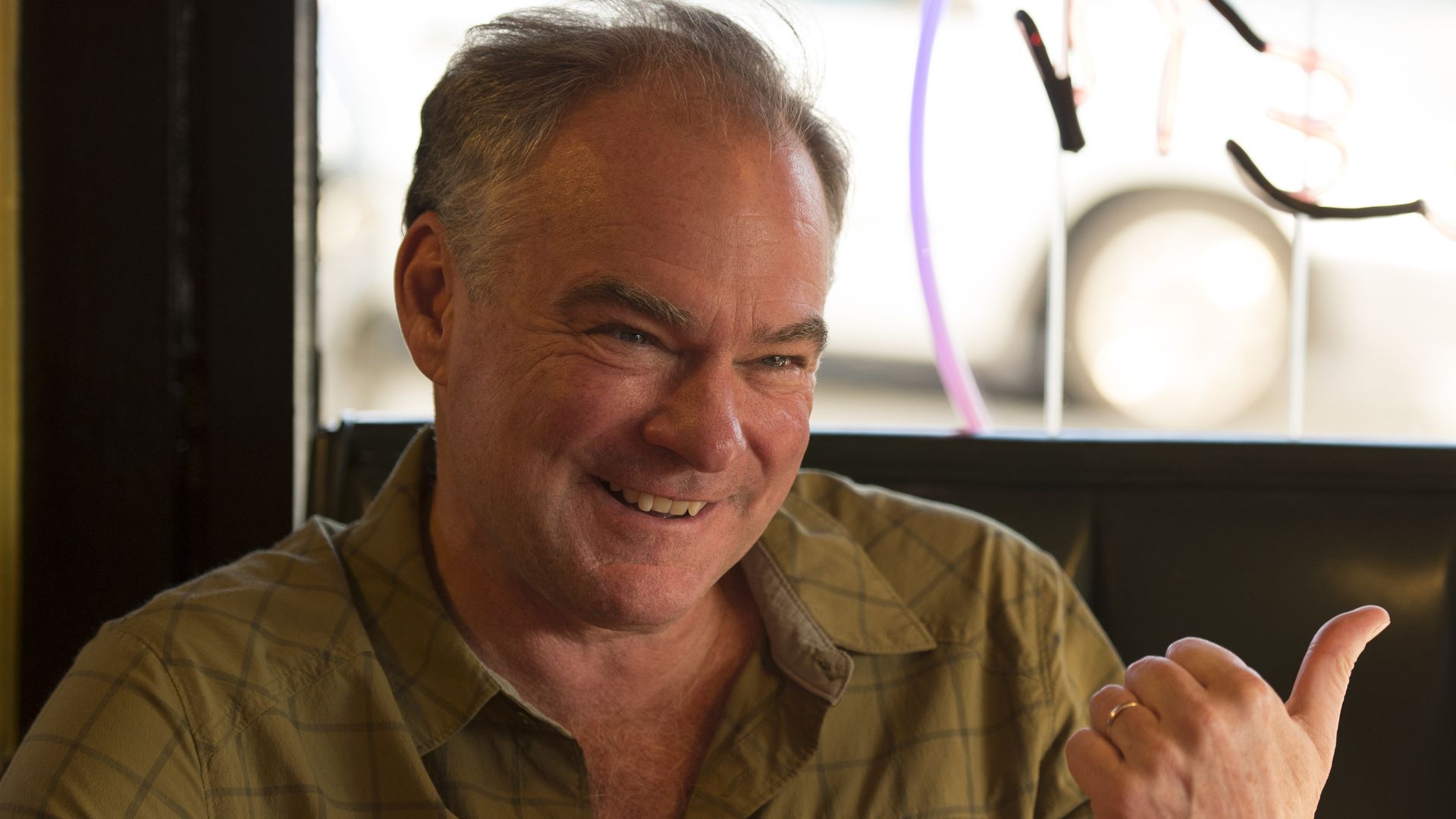 Picture of Sen. Tim Kaine smiling with his thumb pointing out.