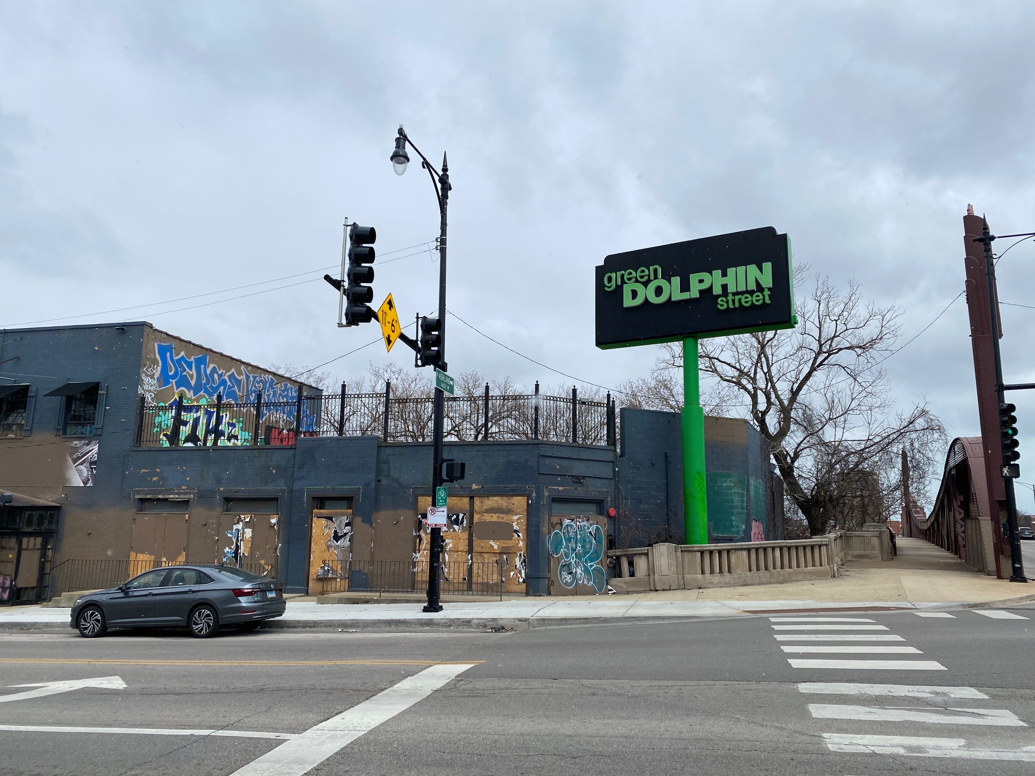 vandalized and boarded up photo of the green dolphin. 