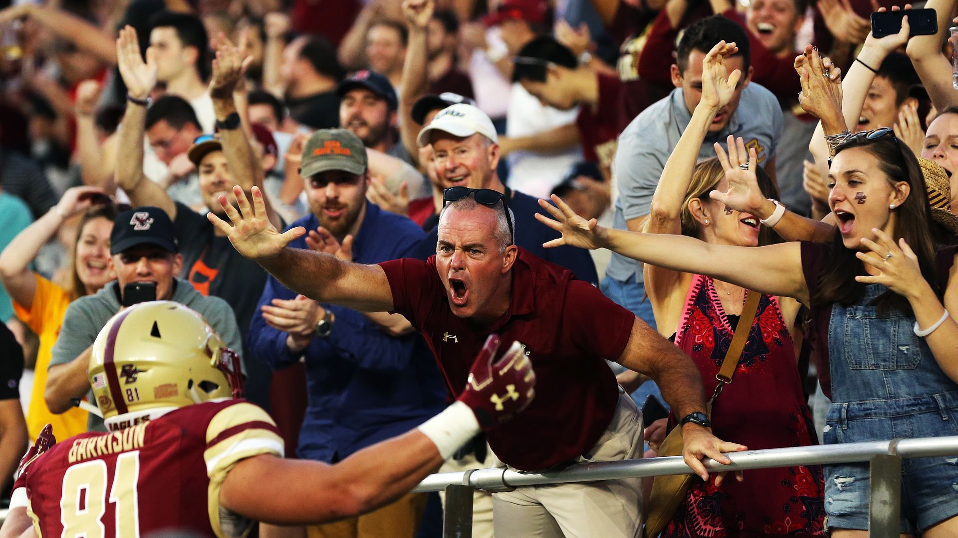 Fan greet a Boston College football player.