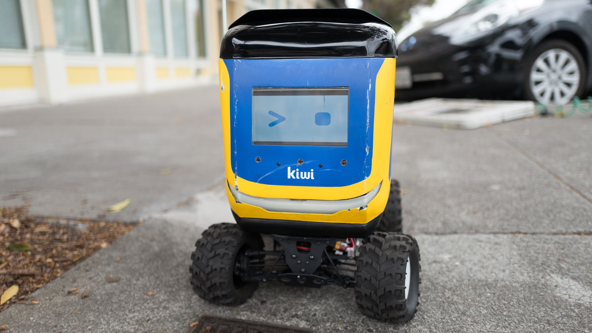 Photo of a sidewalk robot displaying a winking face