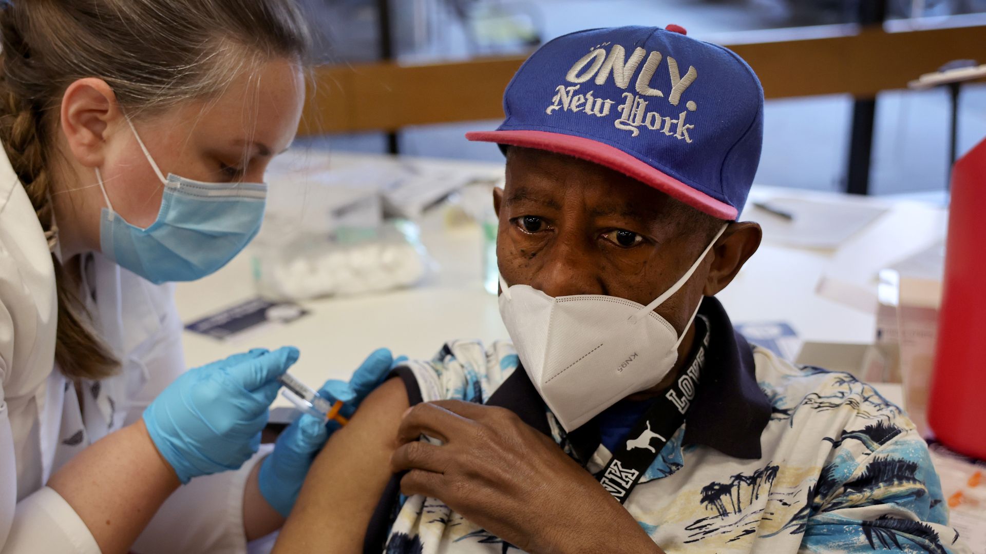 A person receiving a flu shot from a health care worker in Chicago in September 2022.