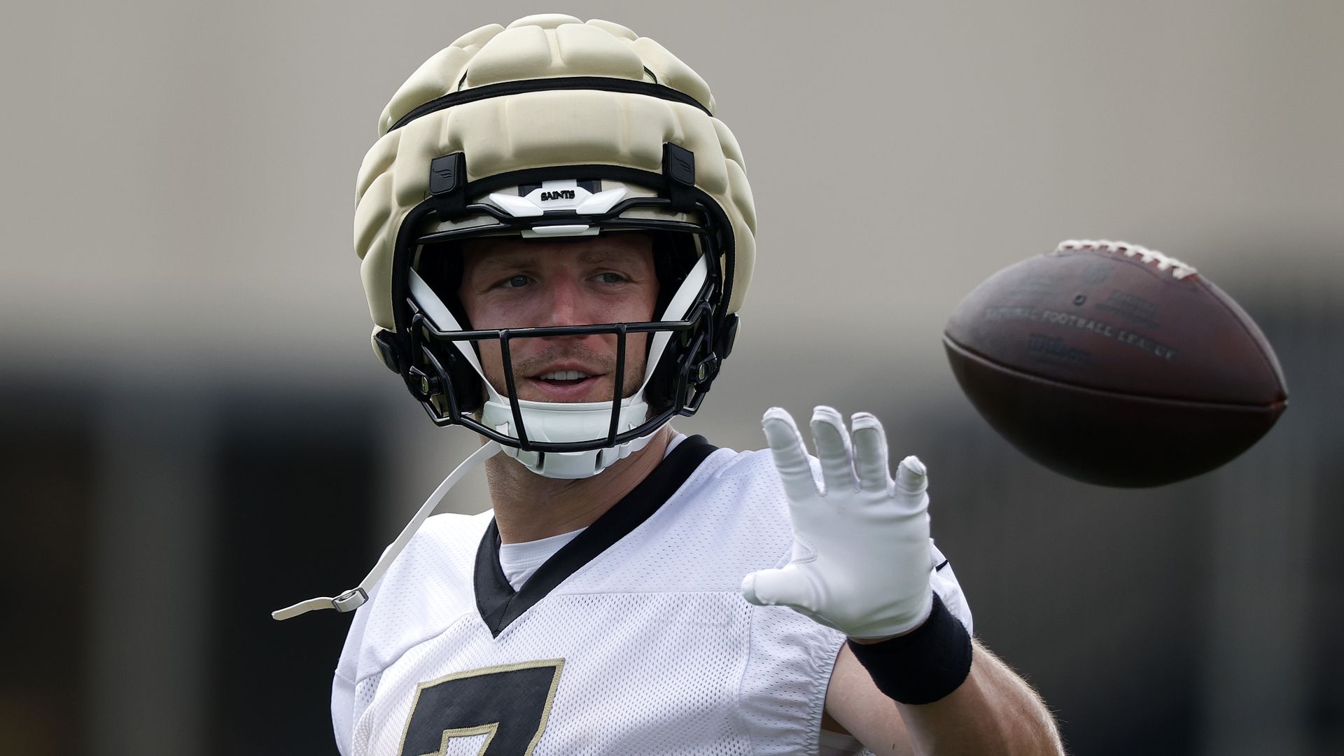 Taysom Hill looks over his shoulder to palm an incoming pass.