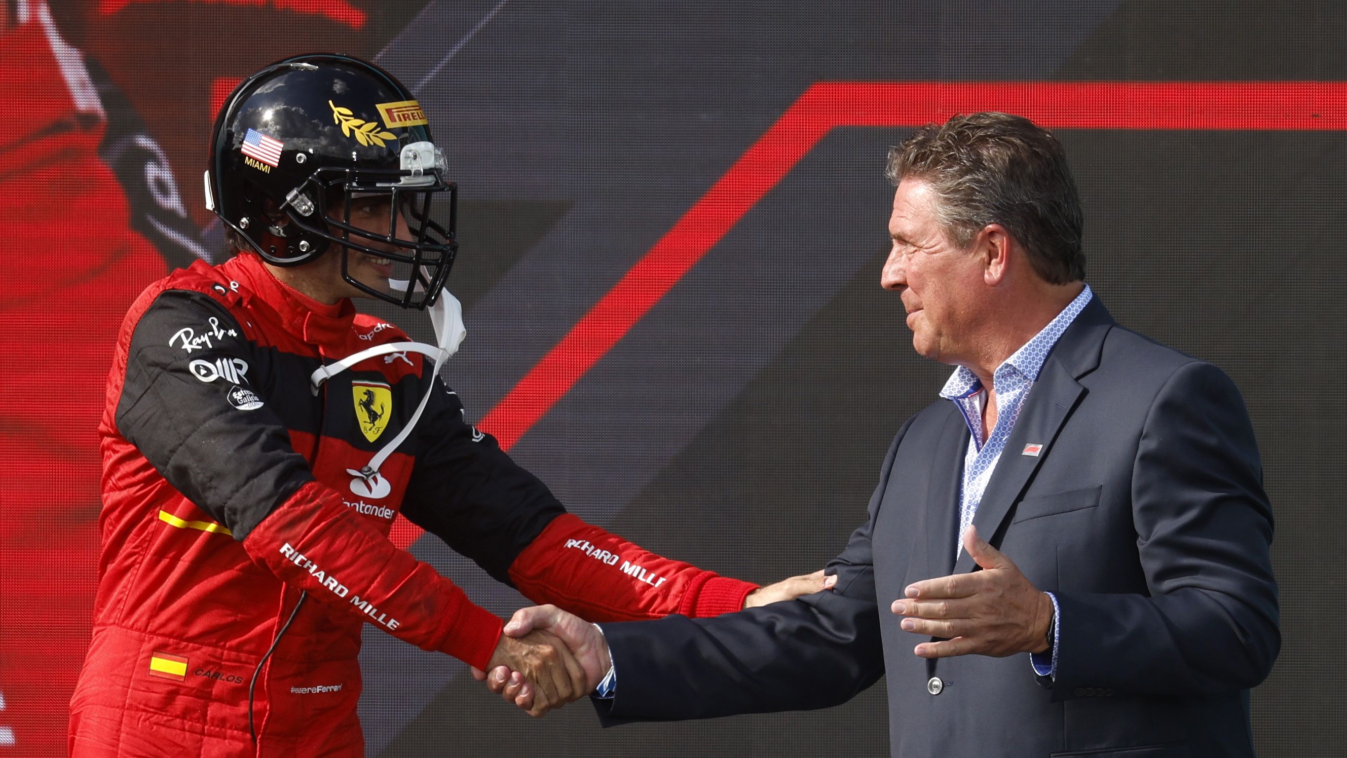They made the top-three finishers at last year's Miami GP wear football helmets on the podium. Here, Ferrari's Carlos Sainz shakes hands with Dolphins legend Dan Marino after coming in third. Photo: Chris Graythen/Getty Images