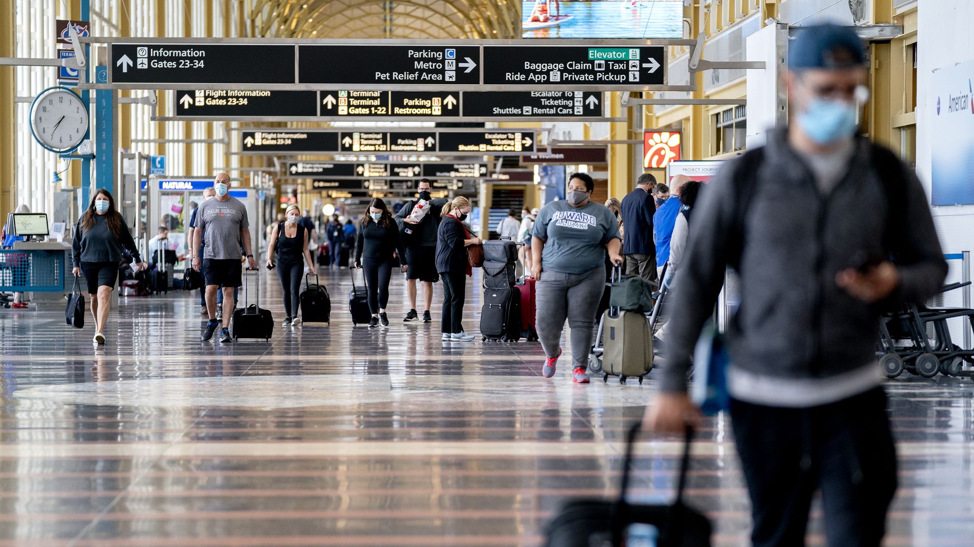 People walk through the airport.