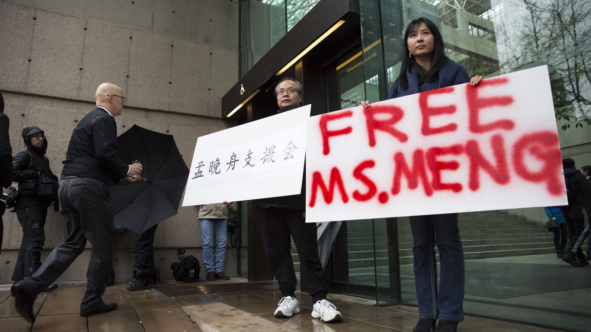 Someone with a poster that says free Ms. Meng
