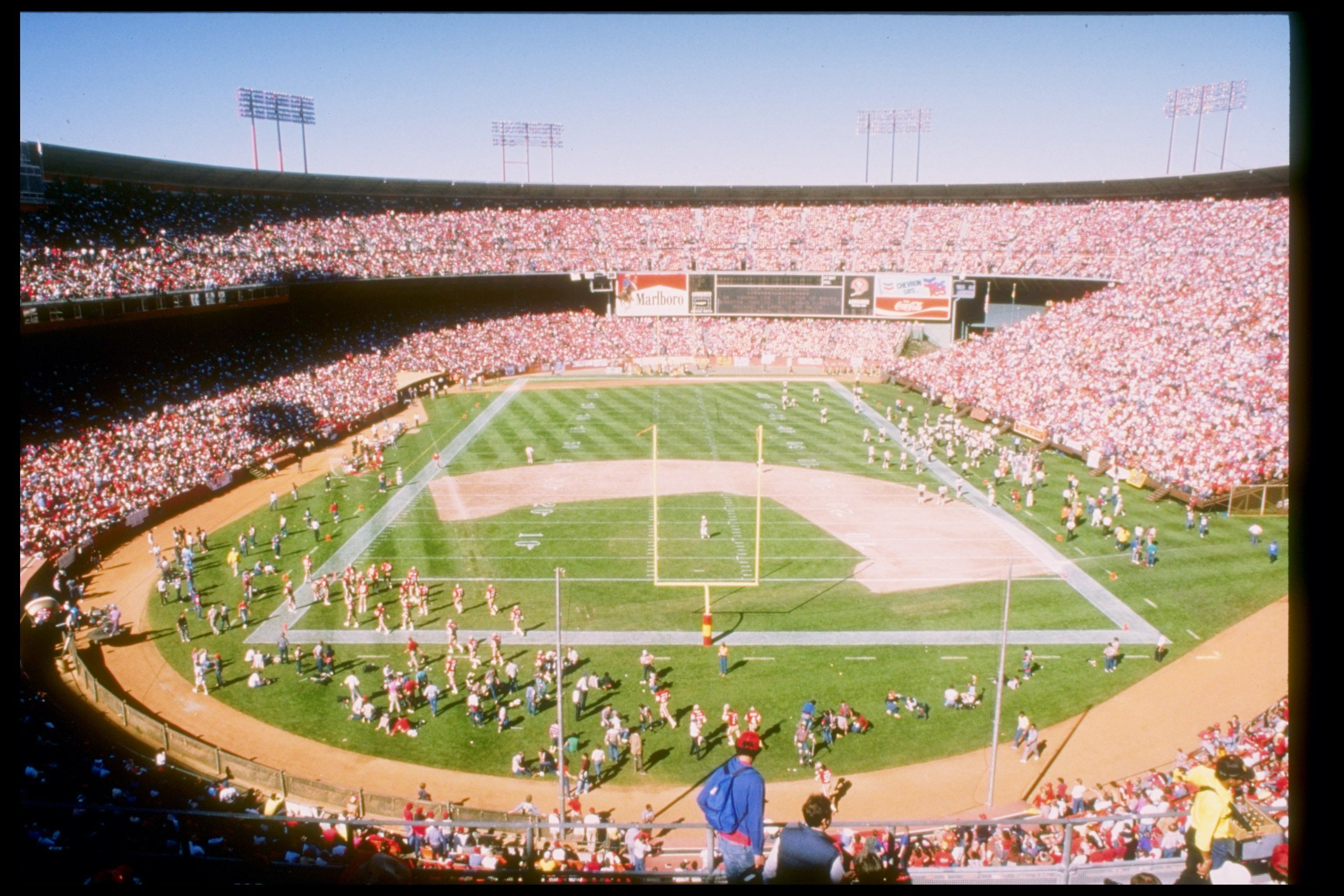 Photo of a stadium filled with spectators before a football game begins. 