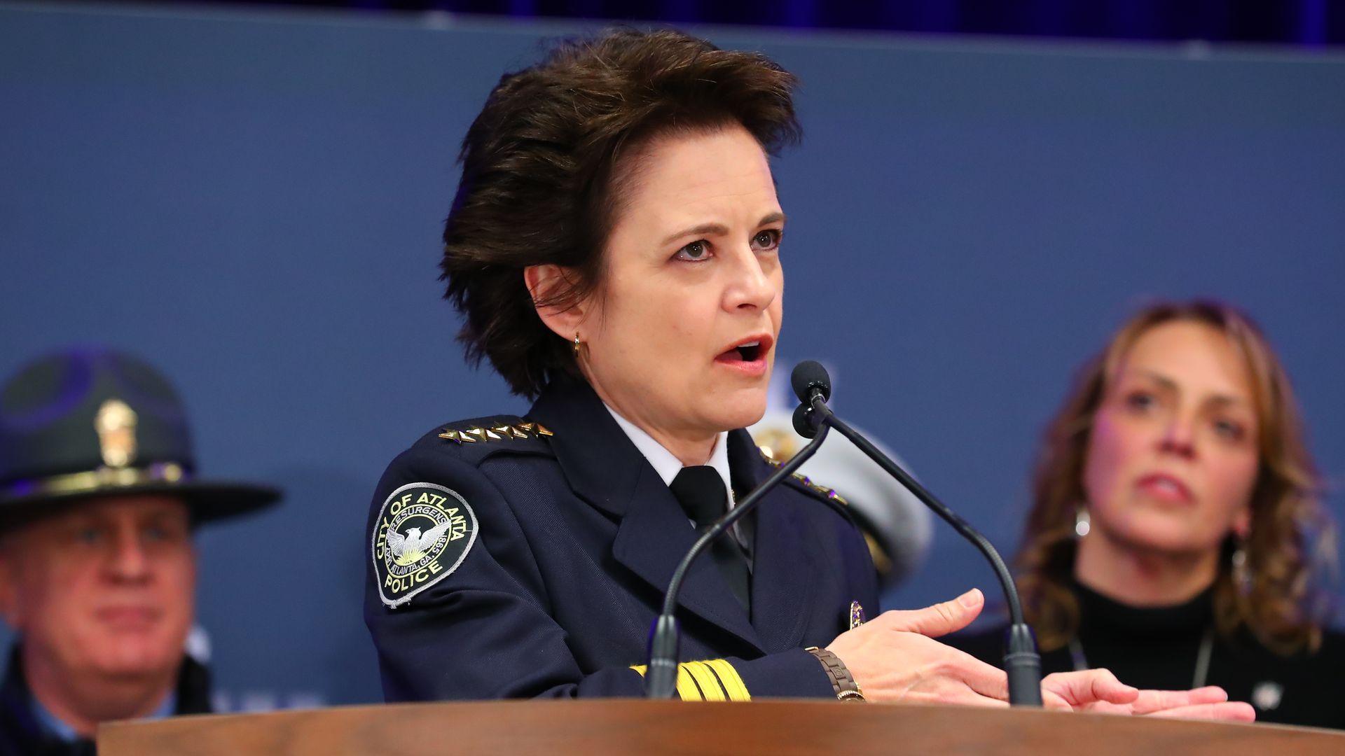 In this image, the Atlanta police chief speaks into a microphone from behind a podium.