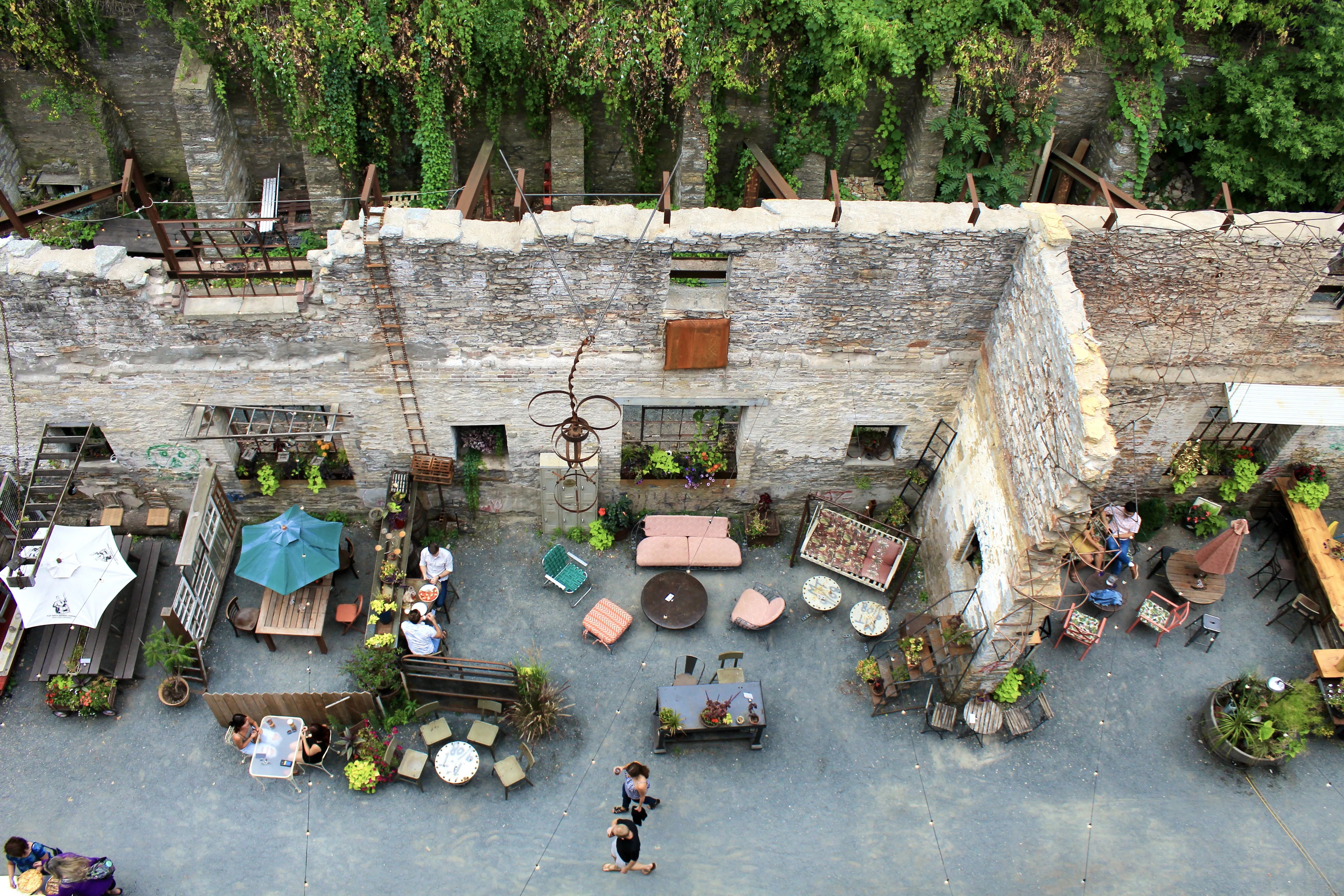 A photo of a patio as seen from above with colorful tables and chairs.
