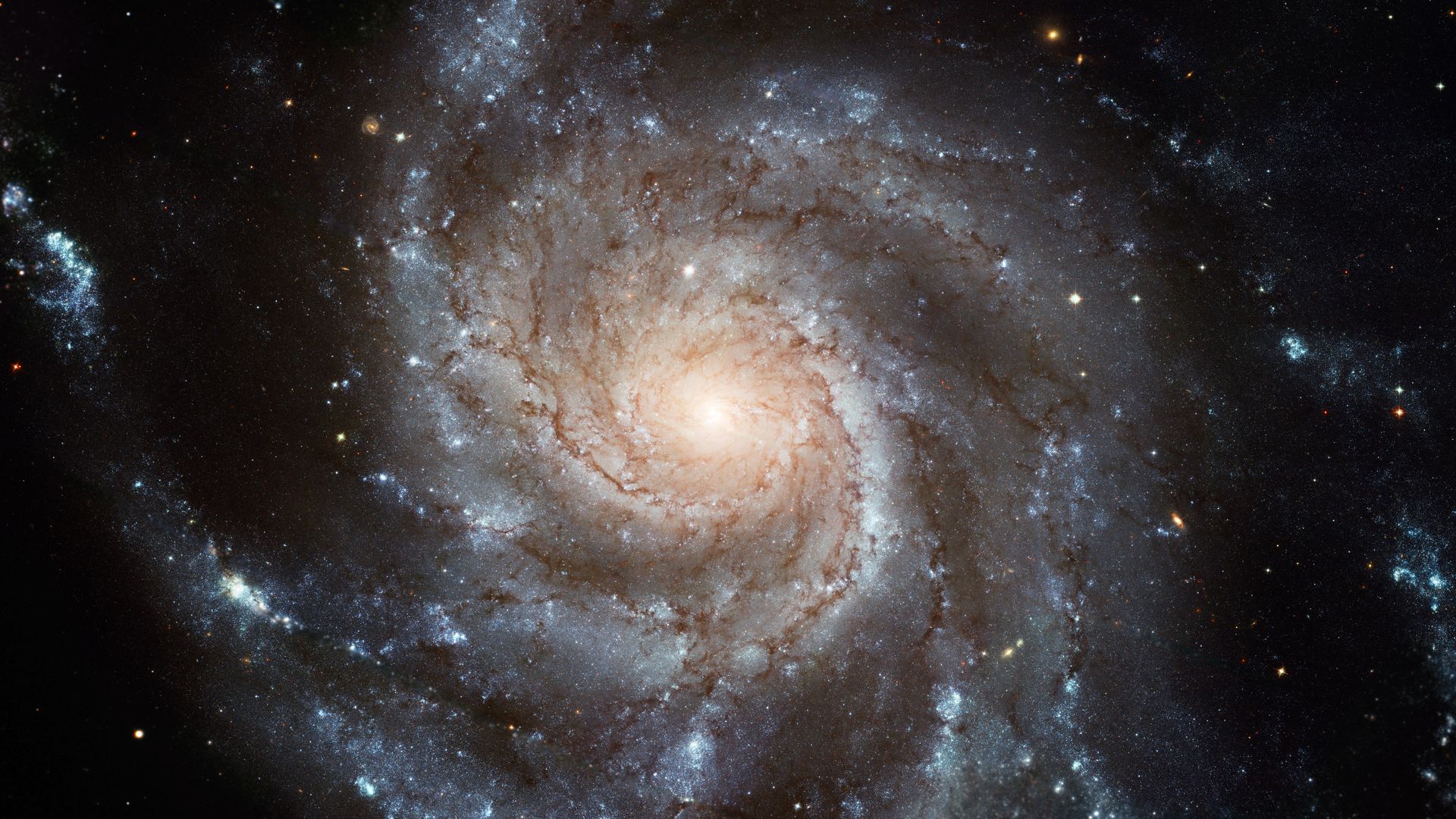 A spiral galaxy with clouds and stars seen by the Hubble Space Telescope