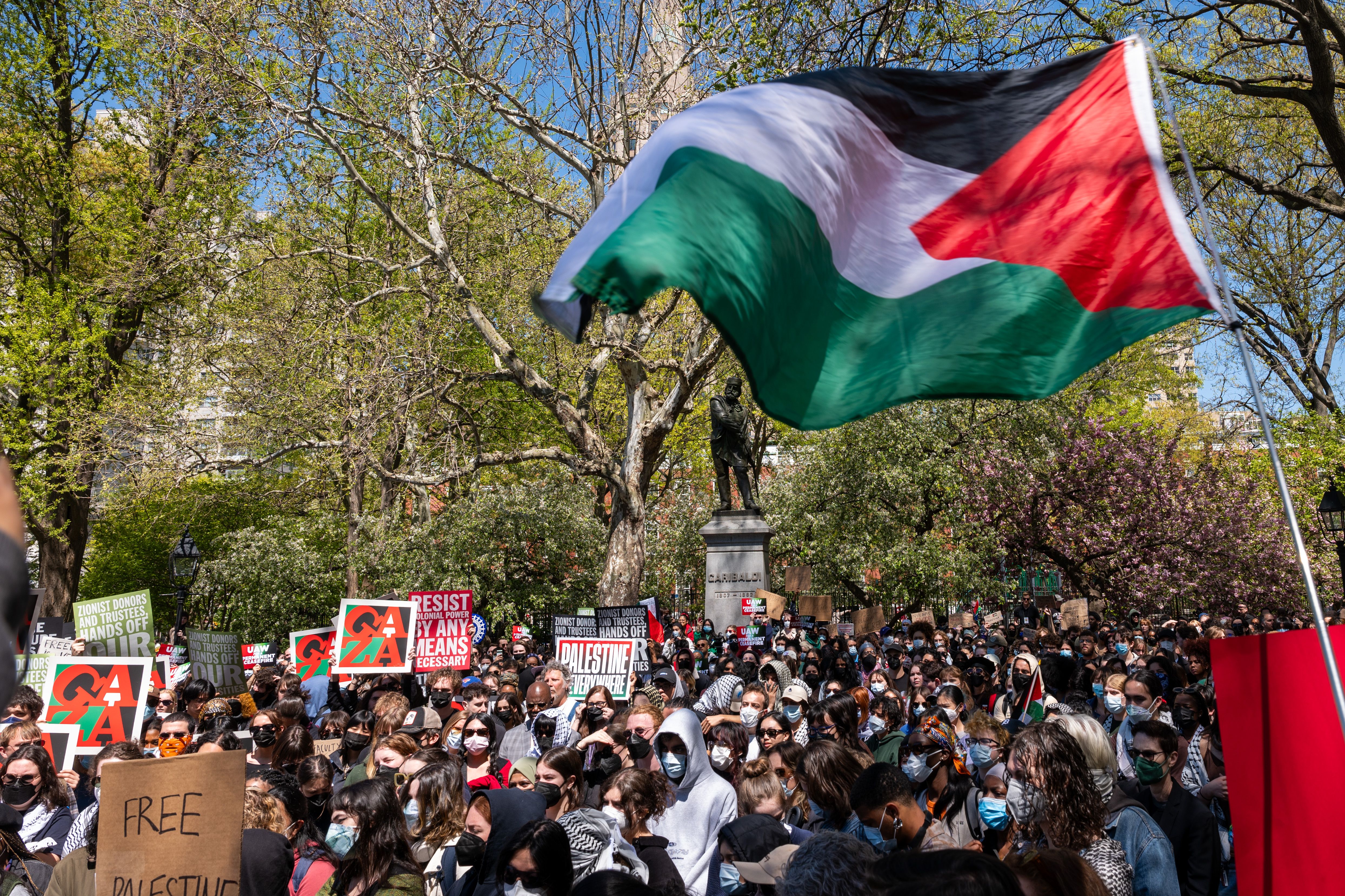NYU students and faculty protest at Washington Square Park in New York City. 