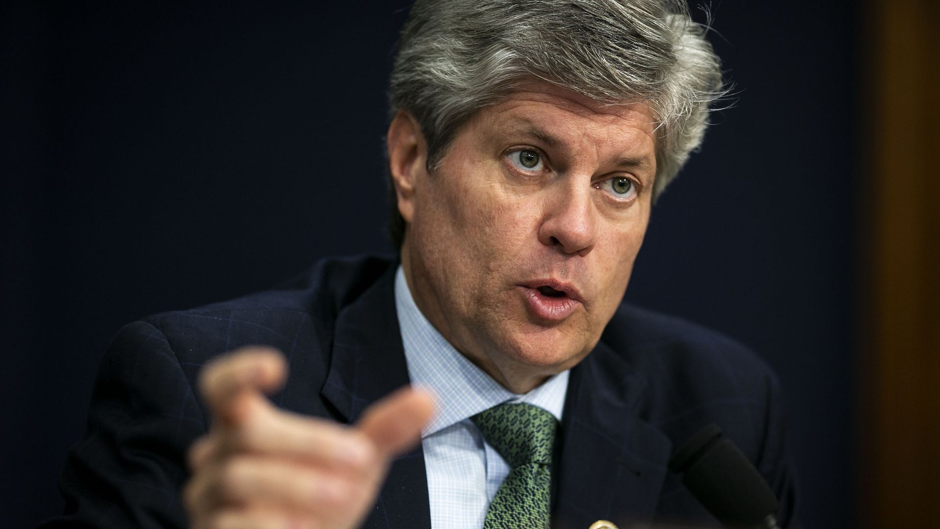 close up image of man in suit speaking.