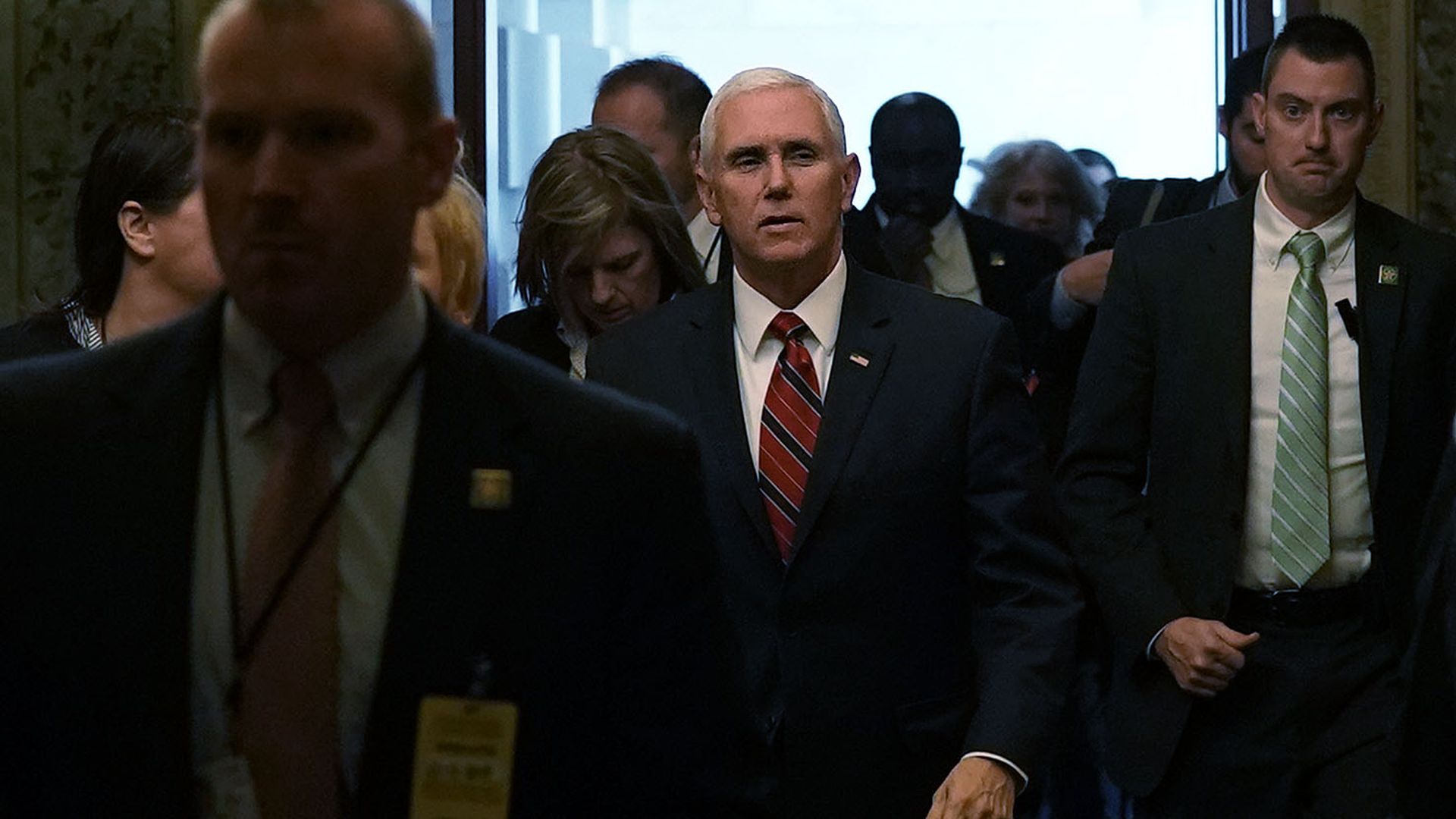 Vice President Mike Pence walks through a crowd of people at the Capitol