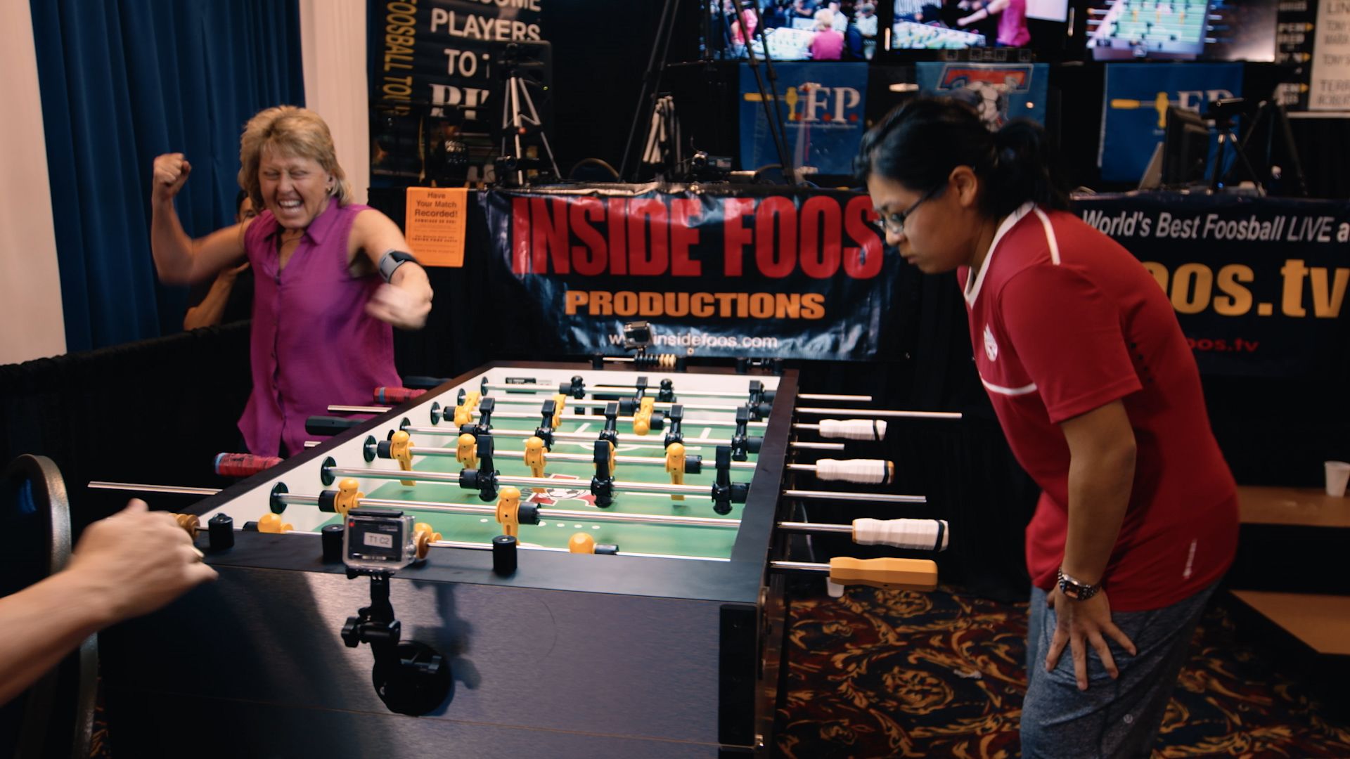 foosball player celebrating a shot