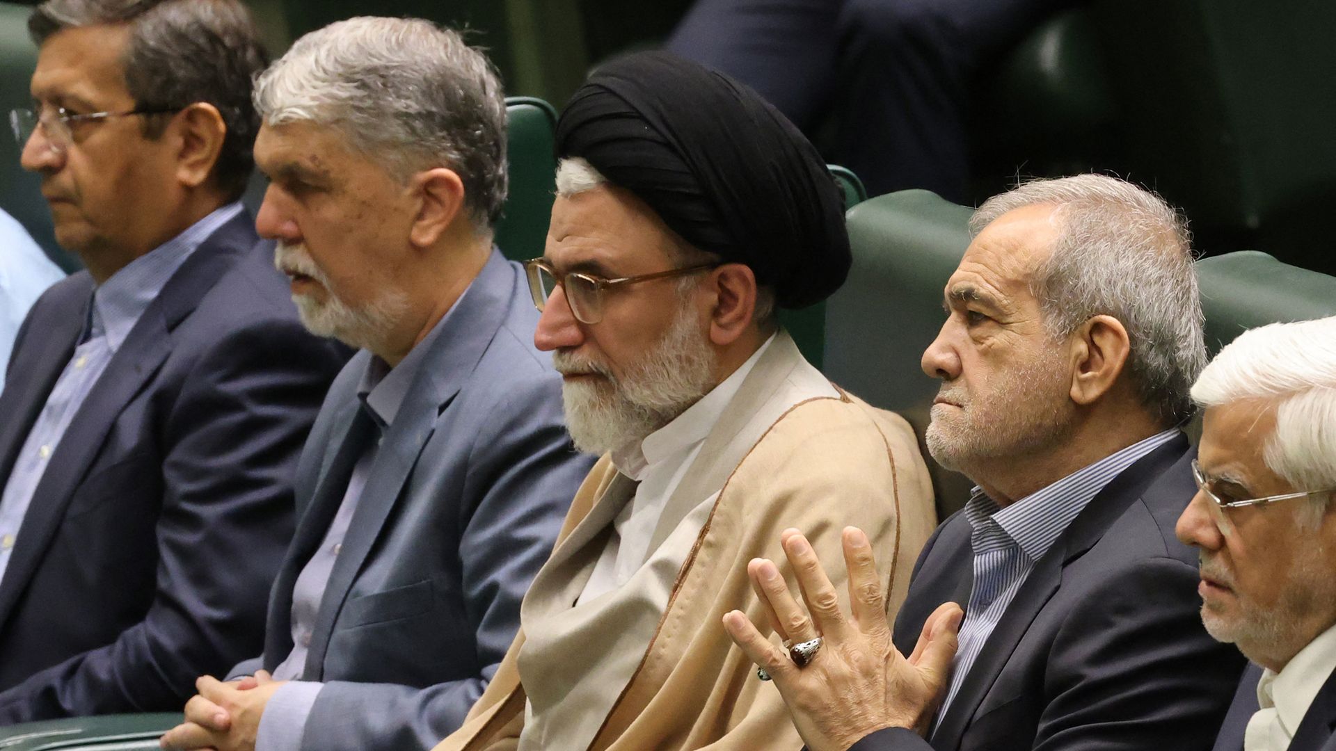 Iranian officials, including Intelligence Minister Esmail Khatib and President Masoud Pezeshkian, seated in a row inside parliament in Tehran.