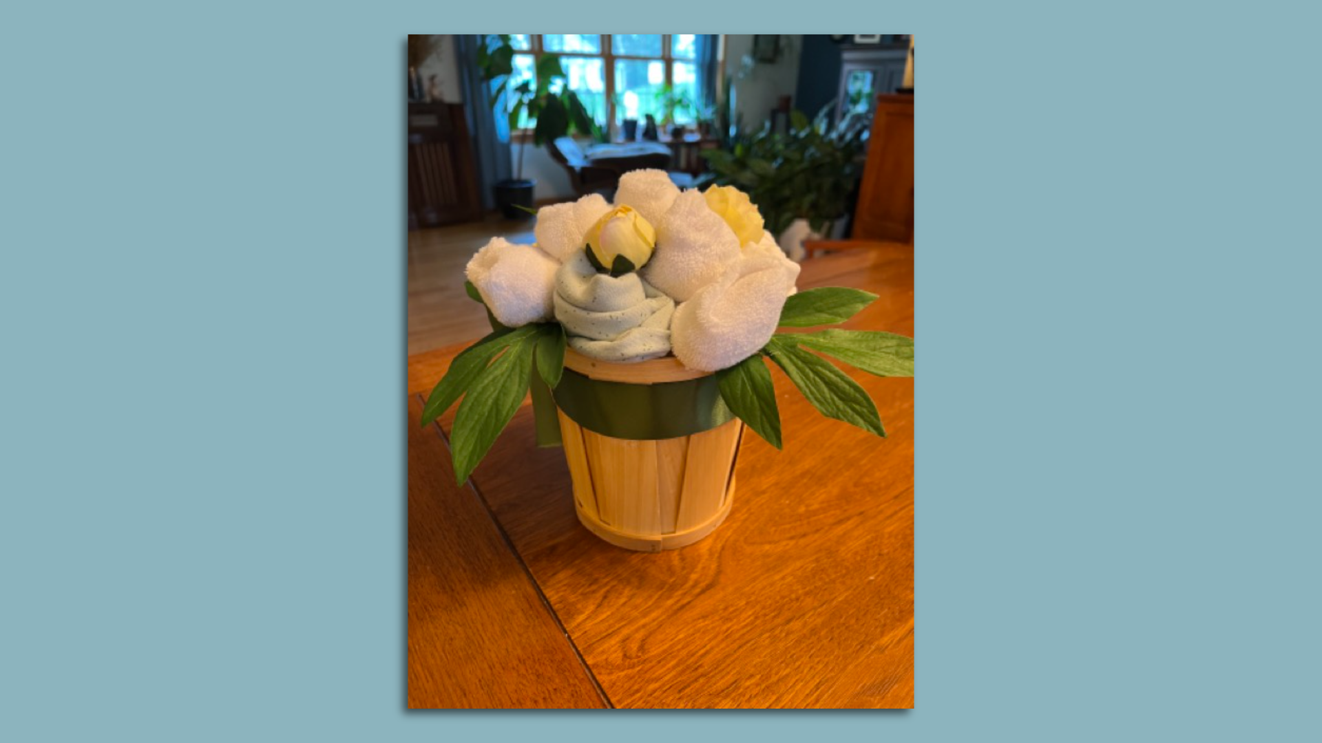 a "bouquet" flower arrangement made of baby clothes