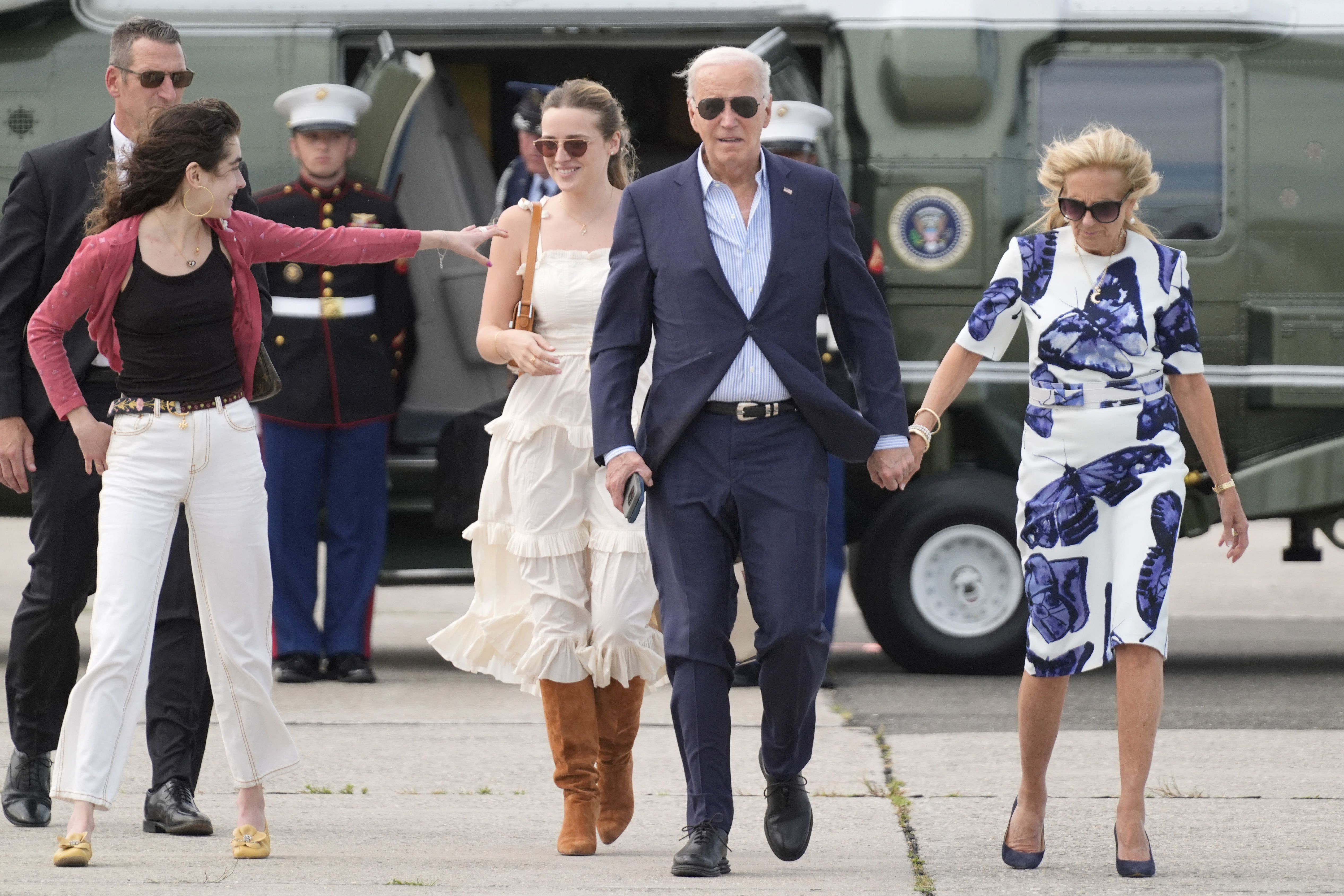 President Joe Biden, center right, and first lady Jill Biden, right, arrive on Marine One with granddaughters Natalie Biden, from left, and Finnegan Biden, at East Hampton Airport,