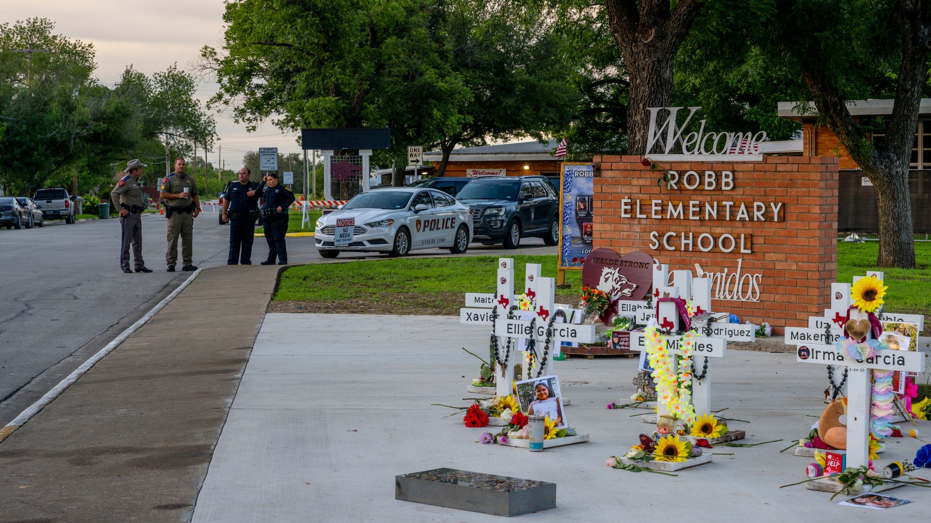 Police on near a memorial for victims of the 2022 mass shooting at Robb Elementary School in May 2023.