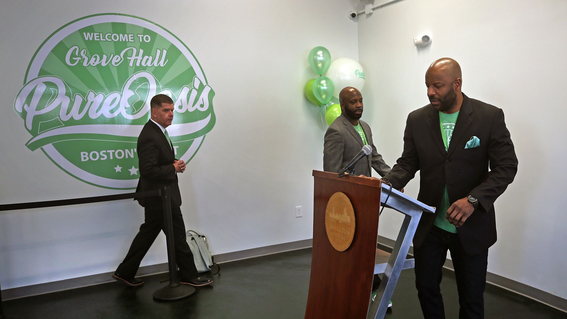 Mayor Walsh, left, enters for a press conference held by co-owners Kevin Hart, center, and Kobie Evans regarding the opening of their store Pure Oasis, Boston's first retail cannabis shop and the Commonwealth's first economic empowerment candidate on March 6, 2020 in Boston