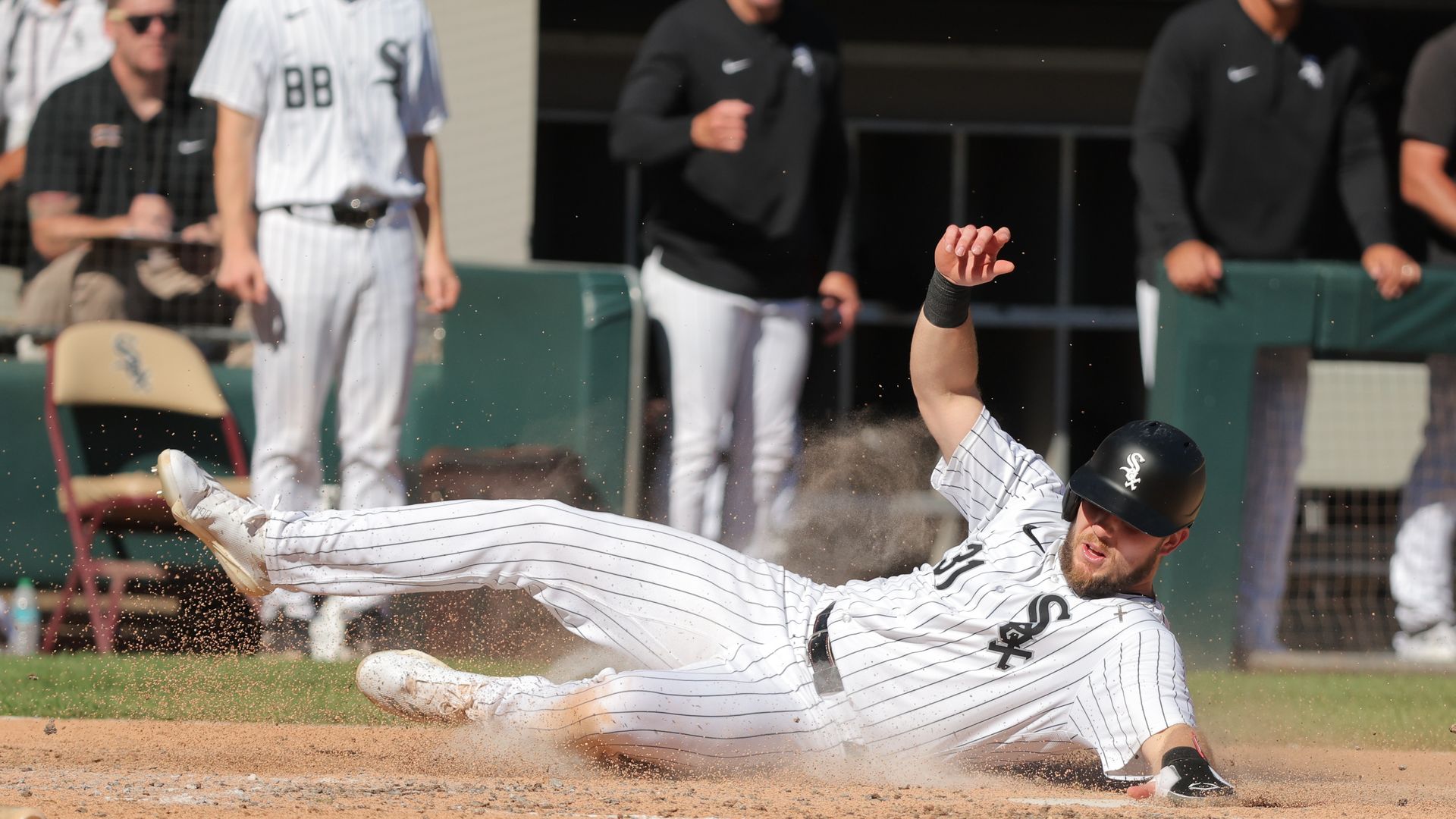 Photo of a baseball player sliding into a base 