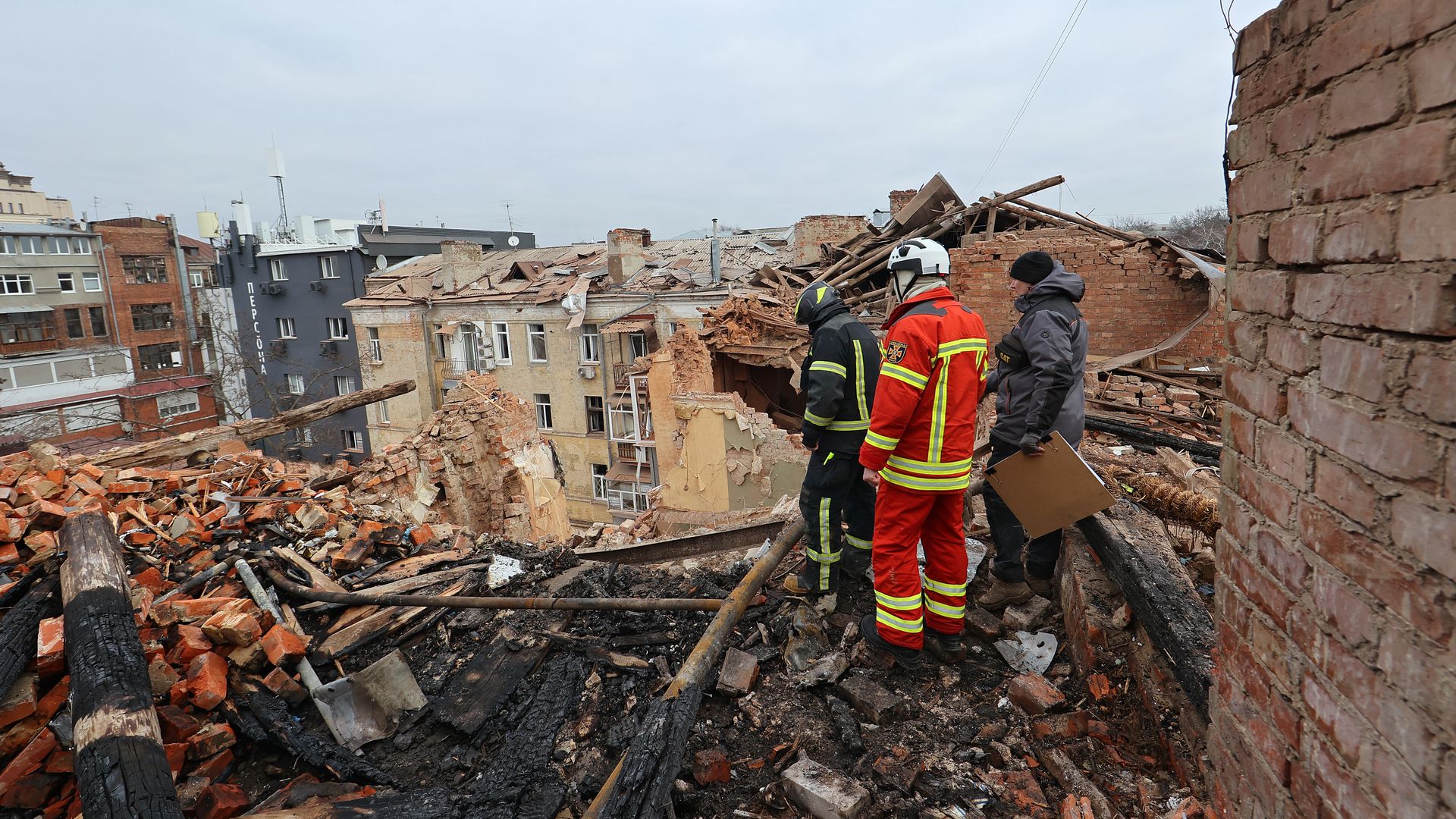 Rescuers are seen at work at a four-storey residential building in Kyivskyi district