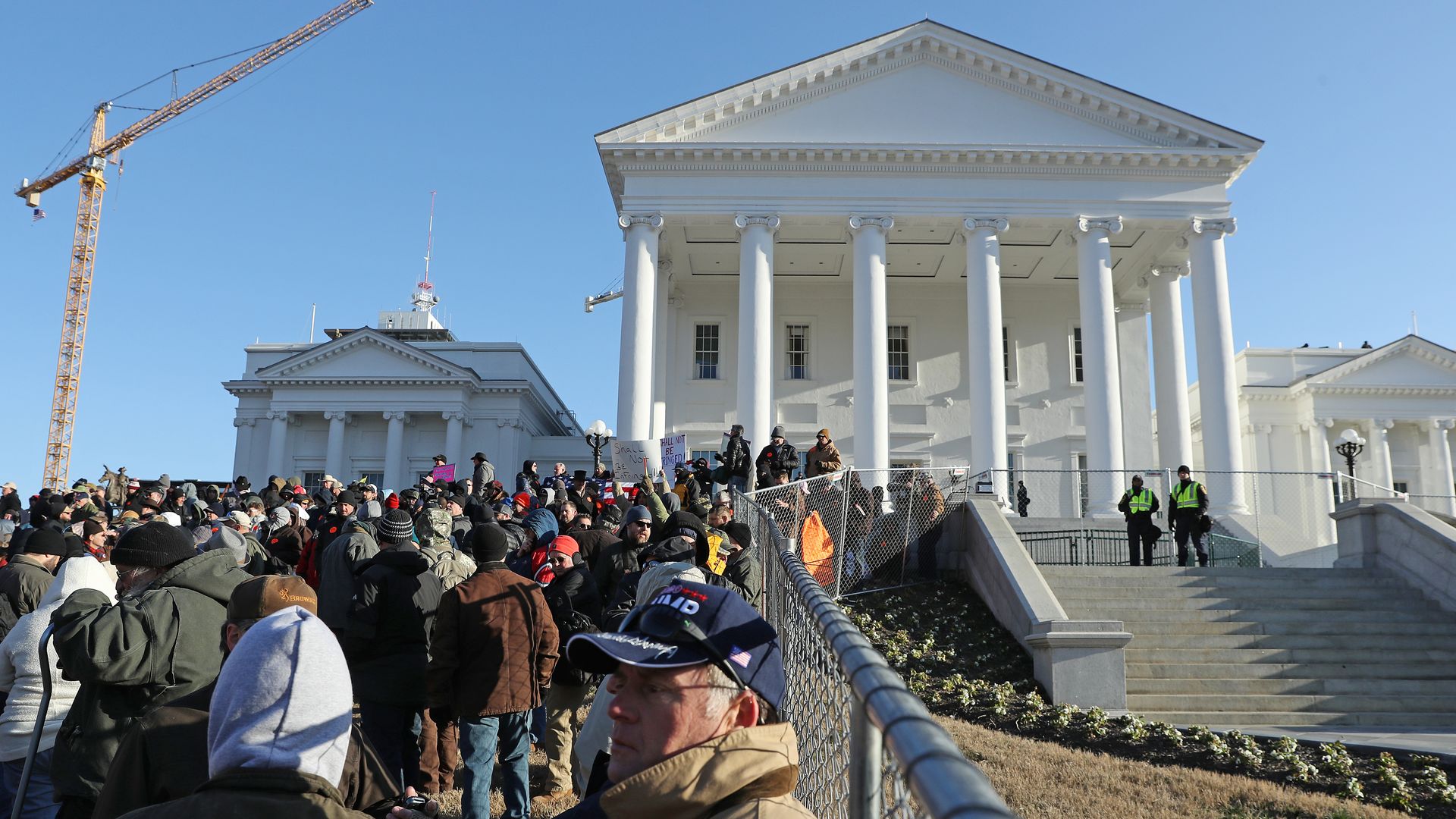 In this image, a crowd of protestors stand outside a virginia courthouse