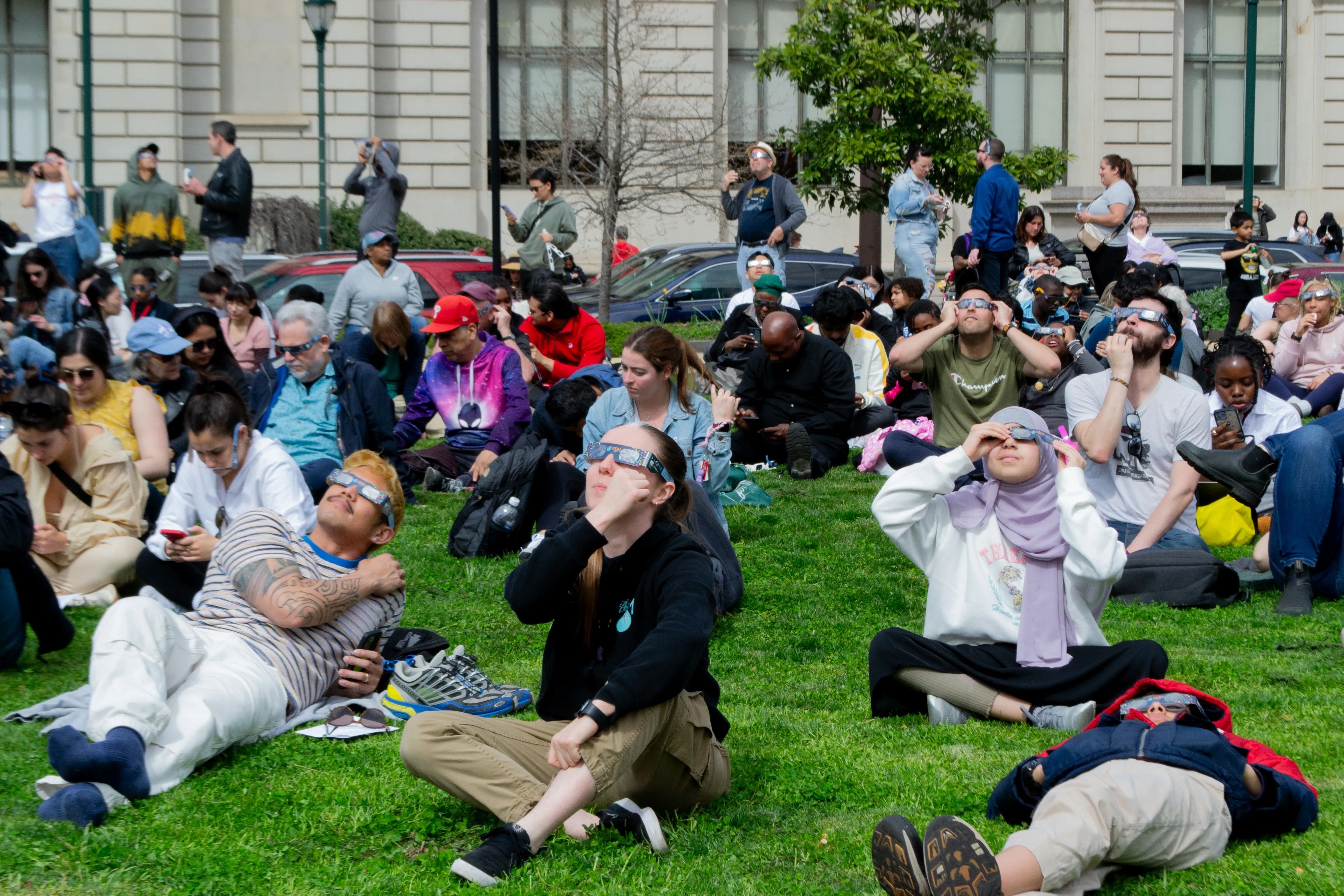 Shakespeare Park outside the Parkway Central Library during the partial eclipse in Philadelphia
