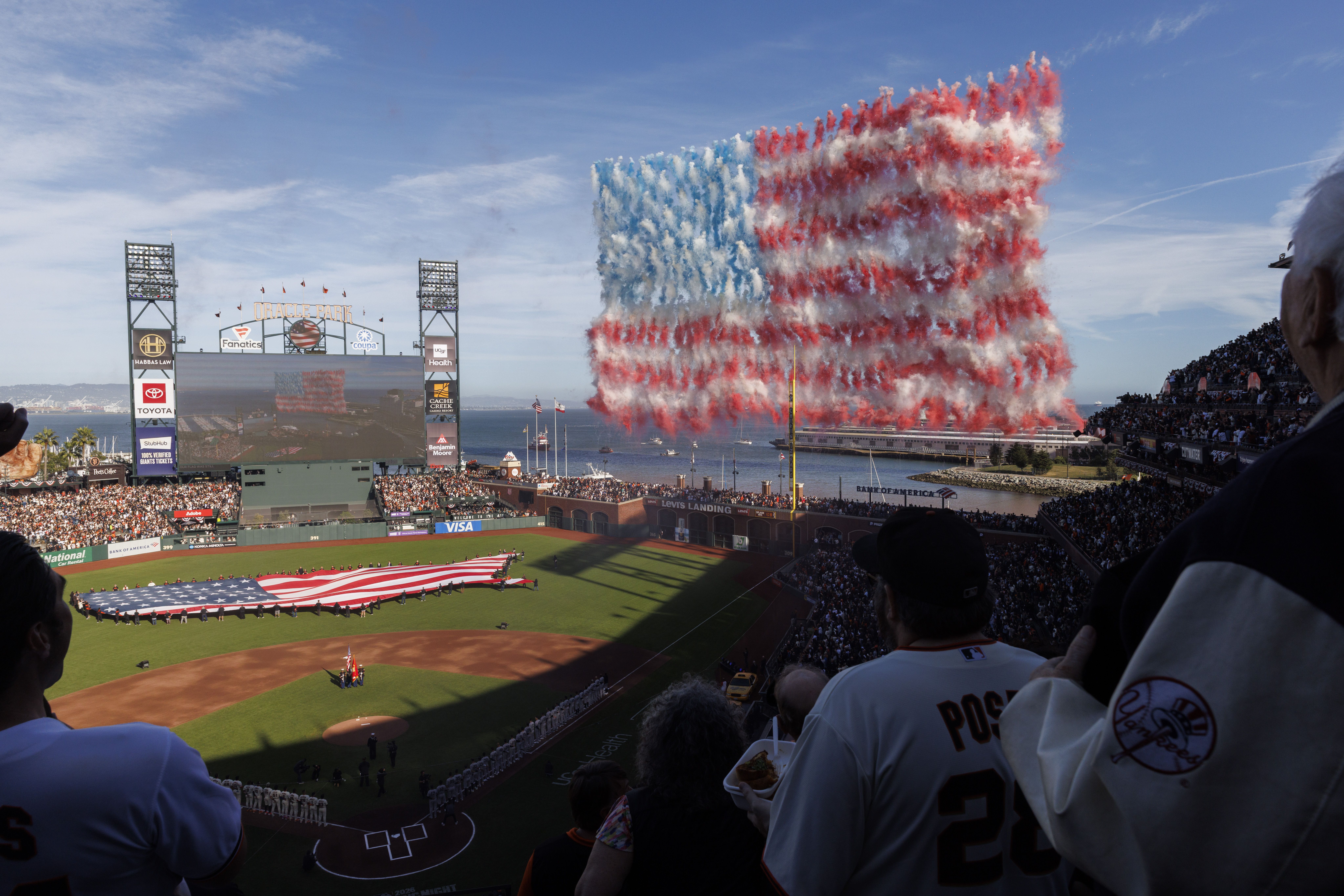 Drones release smoke to create the U.S. flag during the playing of the national anthem for the MLB Opening Night game between the San Francisco Giants and the New York Yankees at Oracle Park
