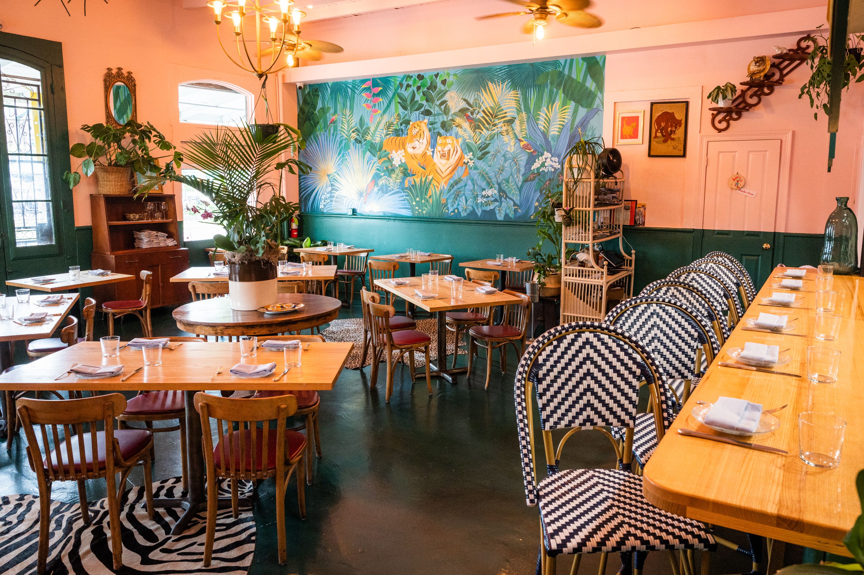 An interior shot of Mister Mao shows a brightly-lit, quirky and whimsical space with tropical-themed decor.