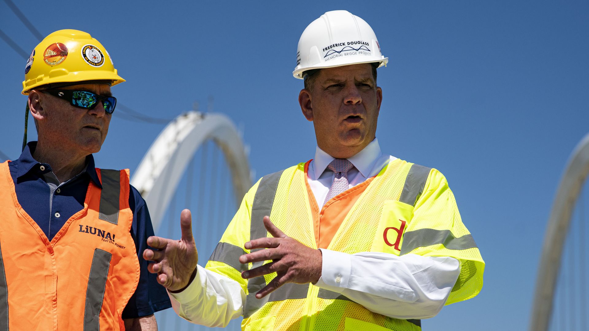 Labor Secretary Marty Walsh is seen in a hardhat on the site of a bridge construction project in Washington, D.C.
