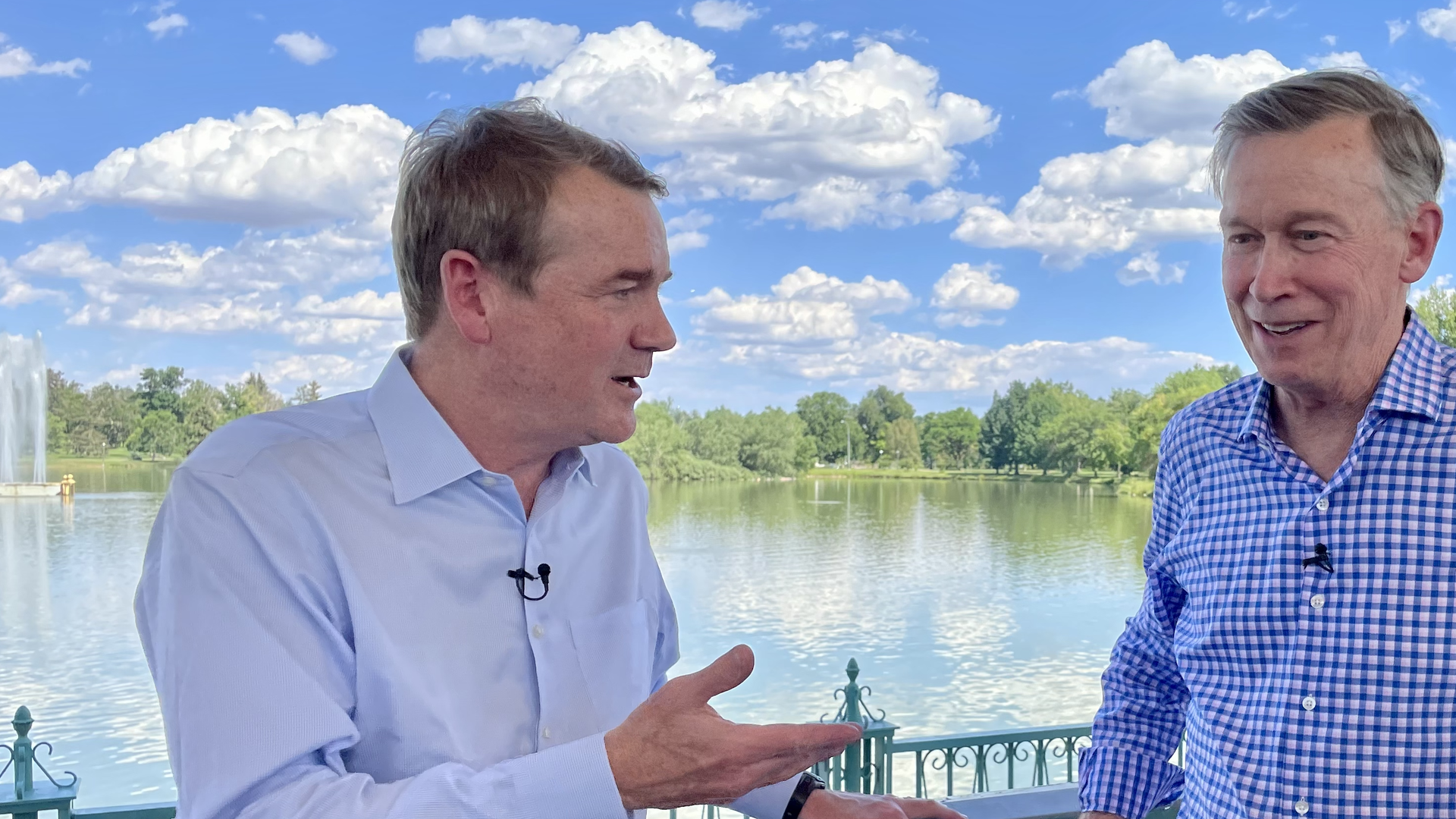 Colorado U.S. Sens. Michael Bennet (left) and John Hickenlooper pitch the "Inflation Reduction Act" at City Park on Tuesday. Photo: John Frank/Axios