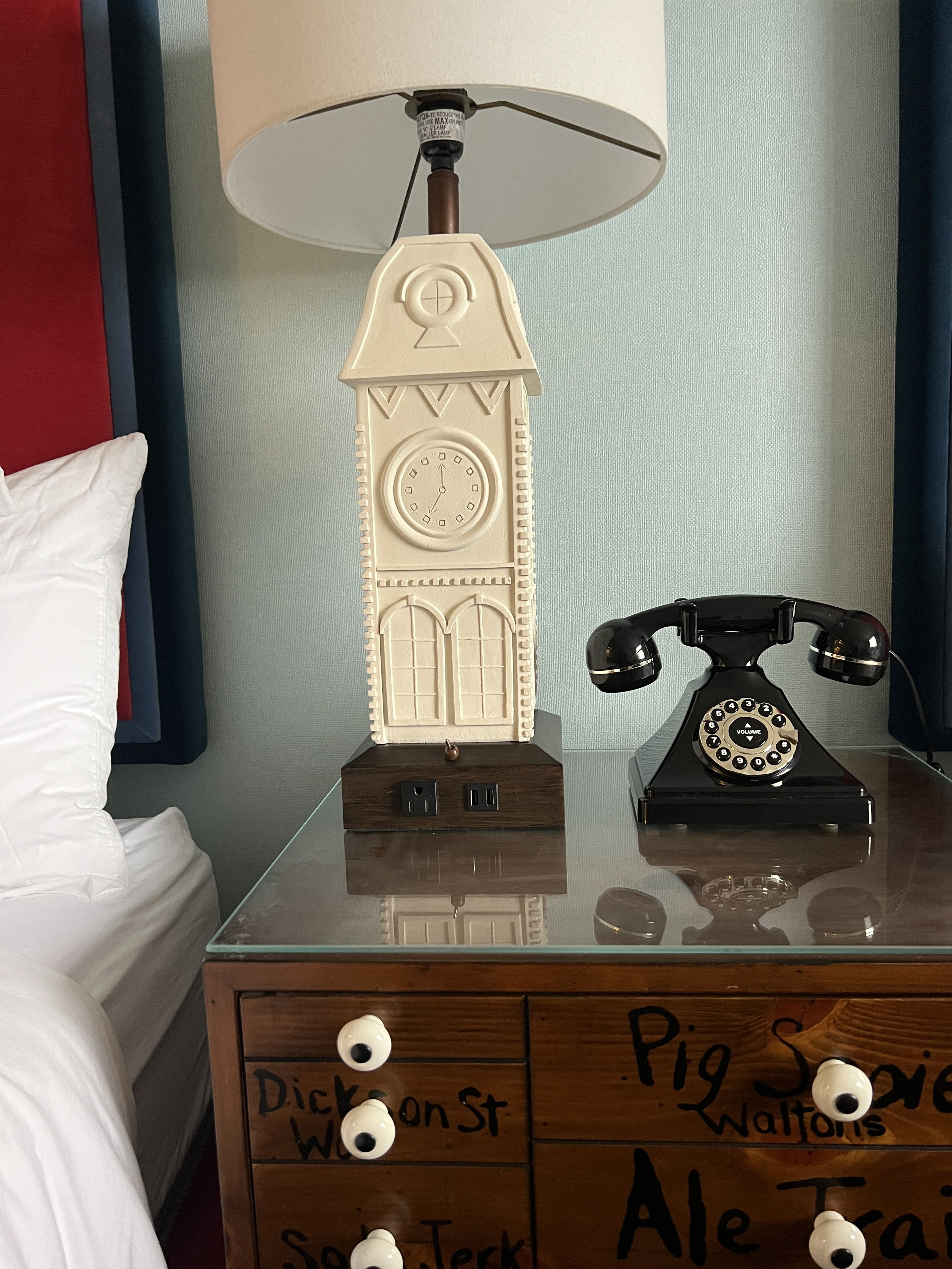 nightstand in hotel room with rotary phone