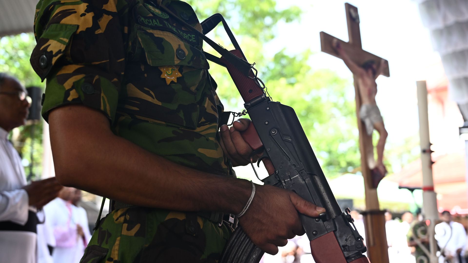 A soldier stands guard near a coffin of a bomb blast victim during a funeral service at St Sebastian's Church in Negombo.