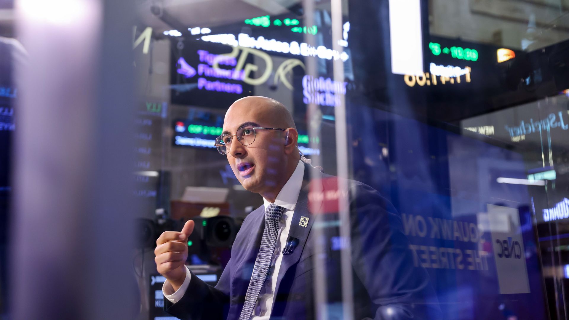 Standard Nuclear CEO Kurt Terrani speaks during an interview on the floor of the New York Stock Exchange, surrounded by ticker boards displaying stock prices.