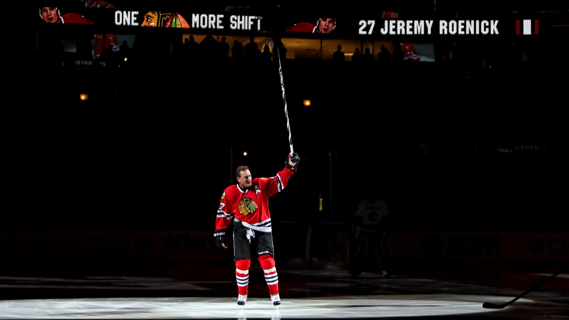 Photo of a man holding a hockey stick on the ice 