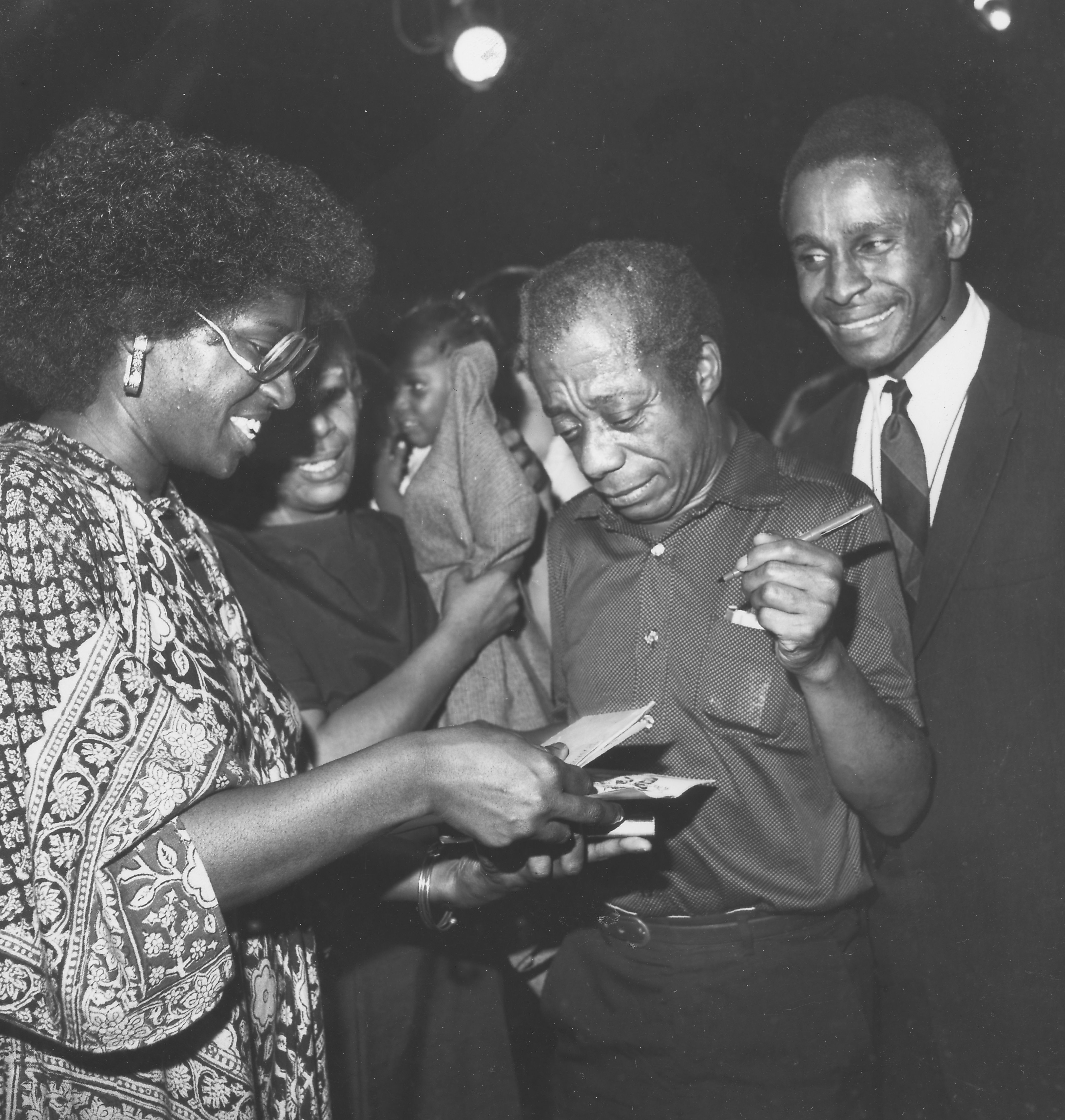James Baldwin, author of "Blues for Mr Charlie," a play in New York city, signing books for fans, with Percy Thomas the lead actor, New York City, December 7, 1980.
