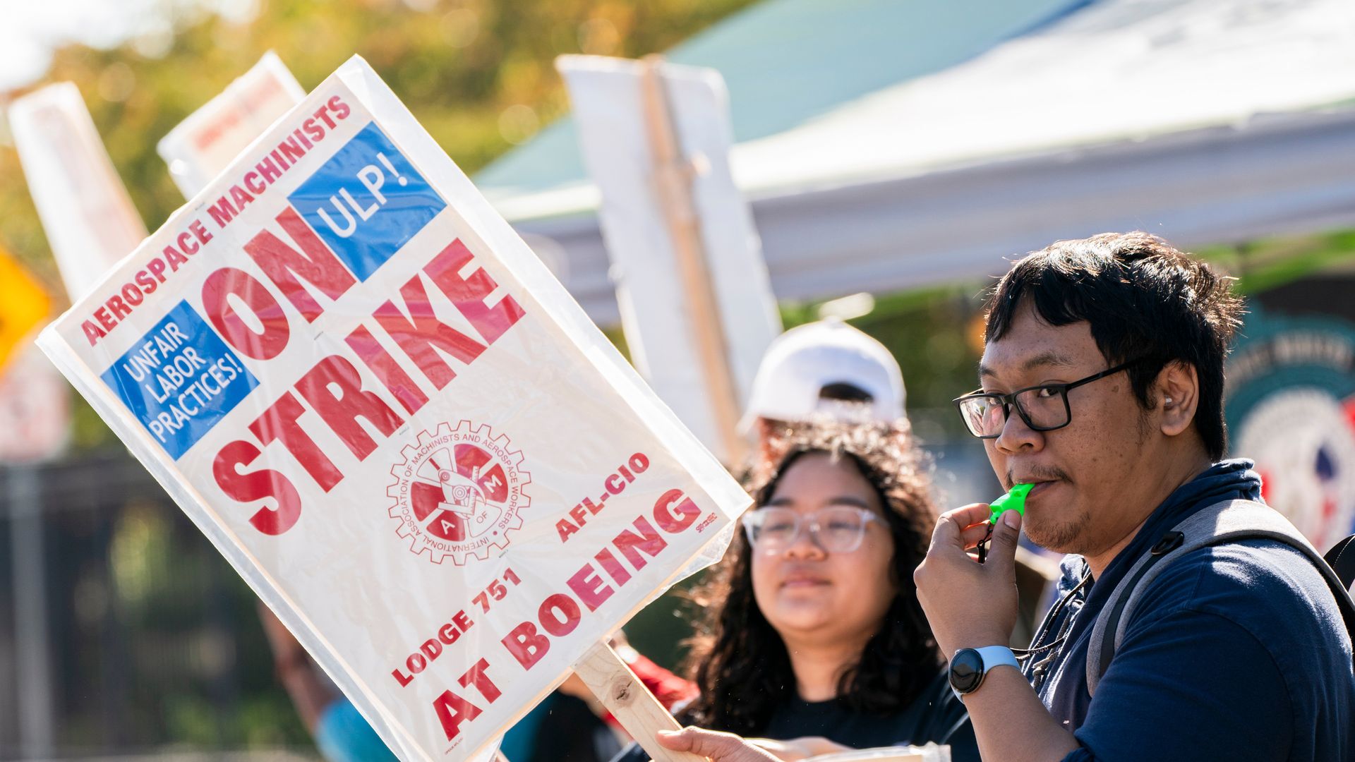 Workers picket with signs outside the Boeing Co. manufacturing facility during a strike in Renton, Washington.