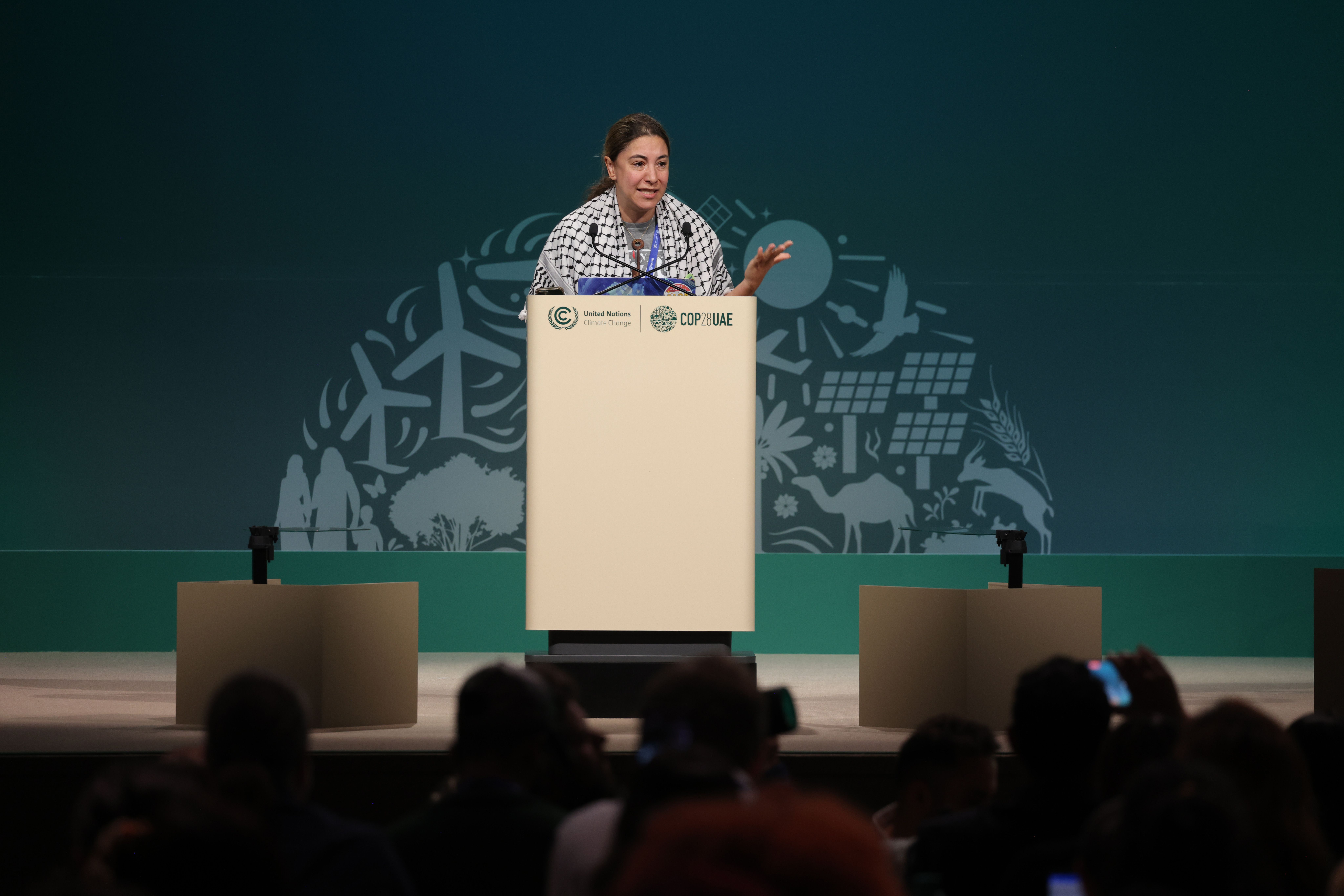 Haneen Jarrar retells her Palestinian family's experience of expulsion and loss in 1948 during the People's Plenary on Dec. 10 at COP28.