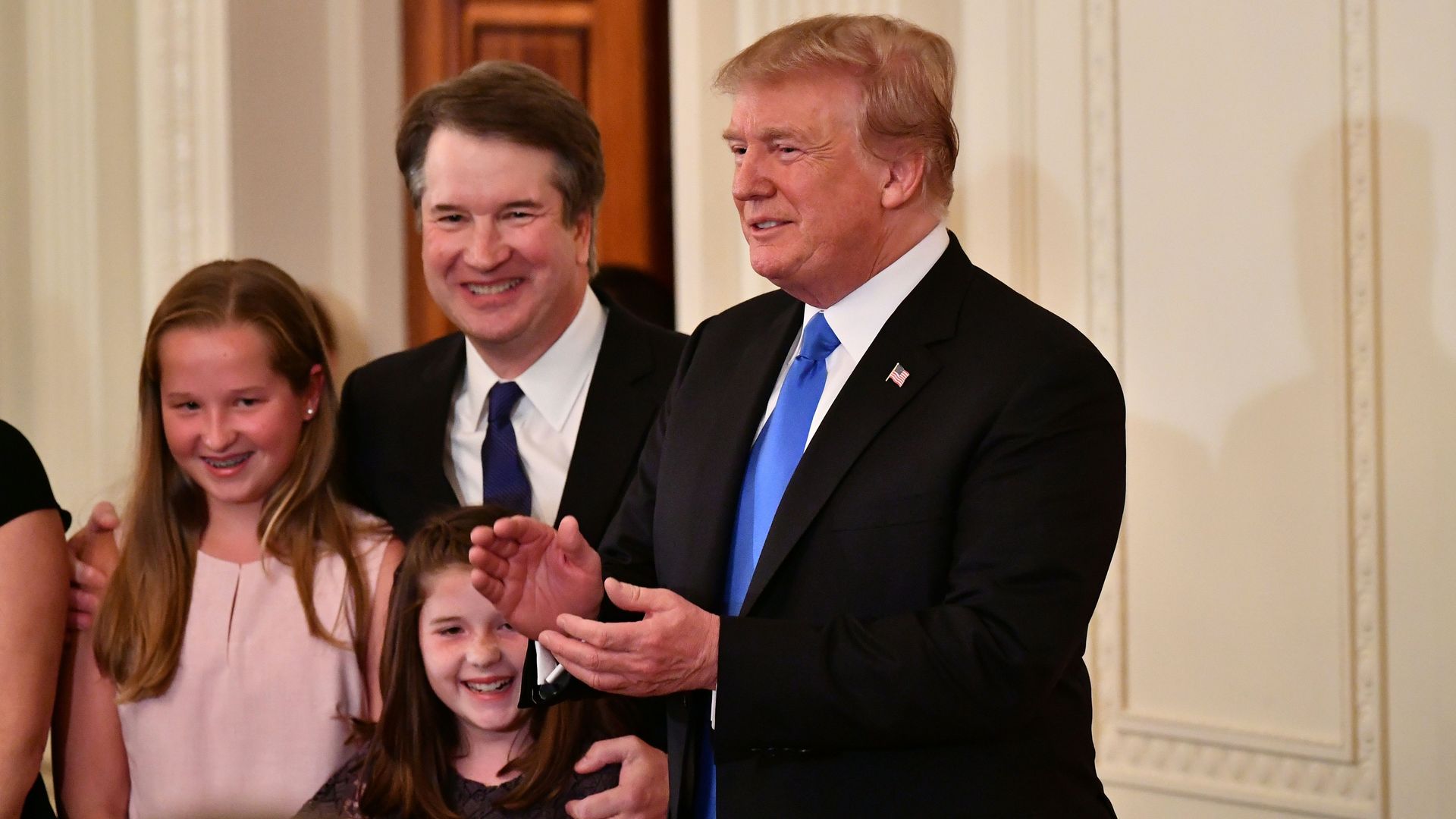 Brett Kavanaugh stands with his two daughters and President Trump.
