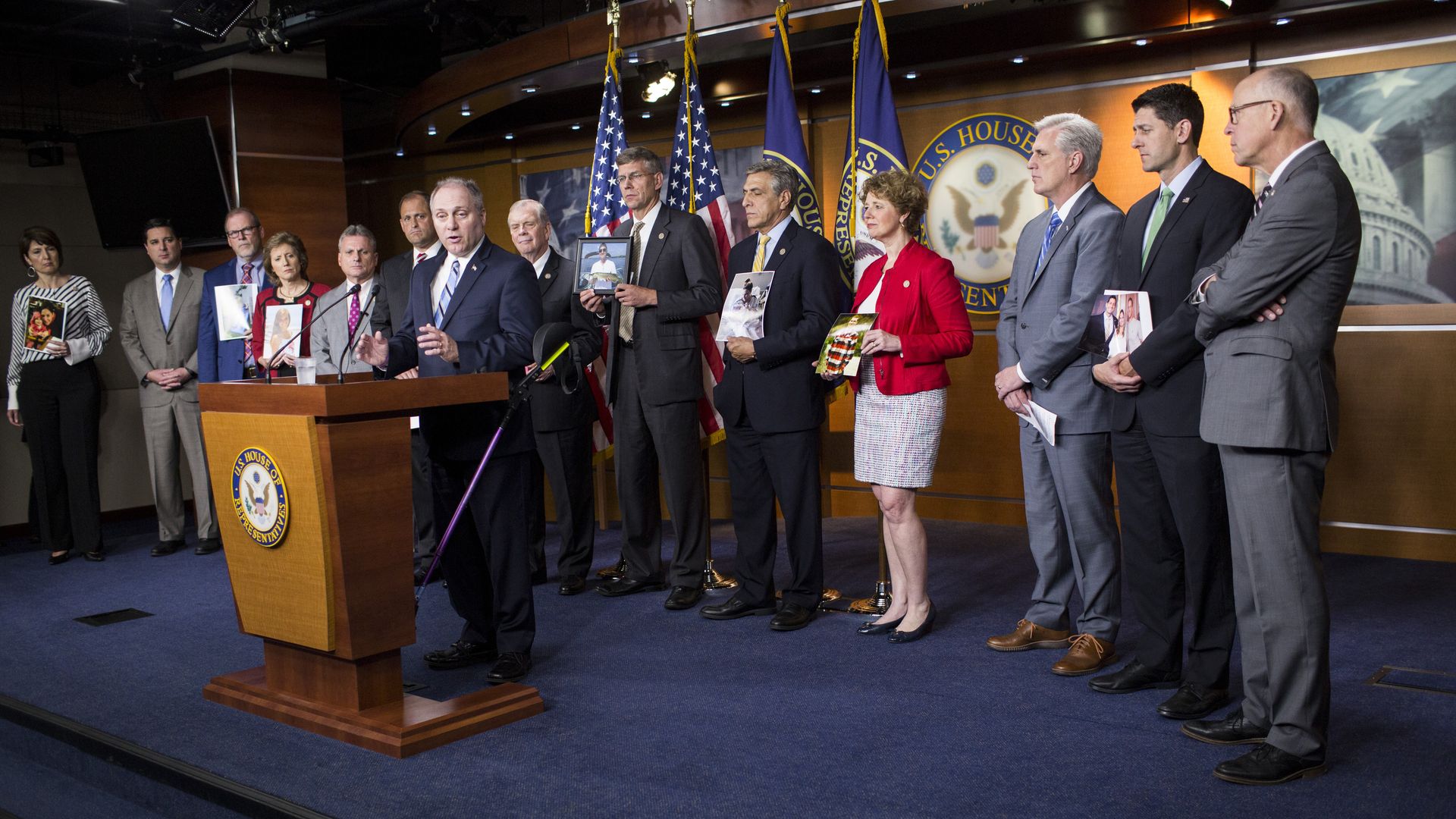 Steve Scalise speaking and surrounded by congressman