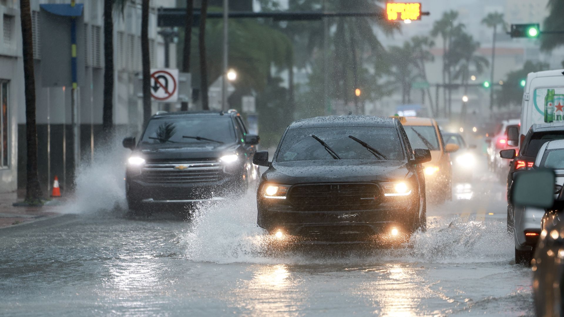 Cars travel through floodwaters in Miami, Florida on Wednesday.