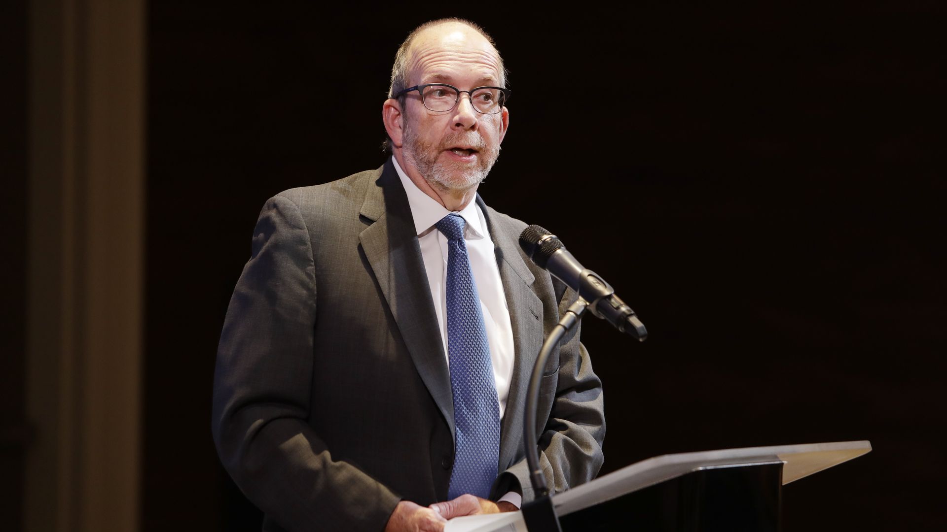 Kent Oliver speaks at a podium.