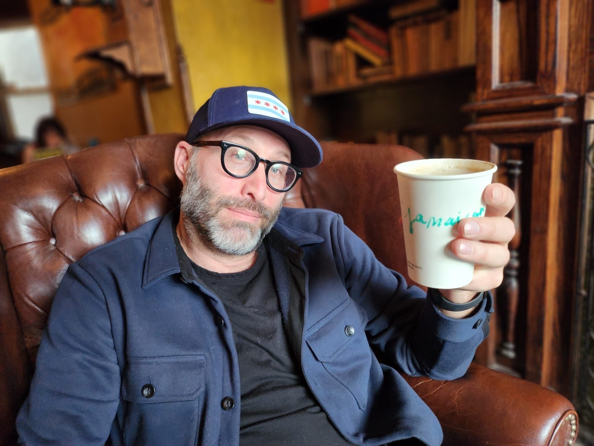 Photo of a man holding a cup of coffee. 