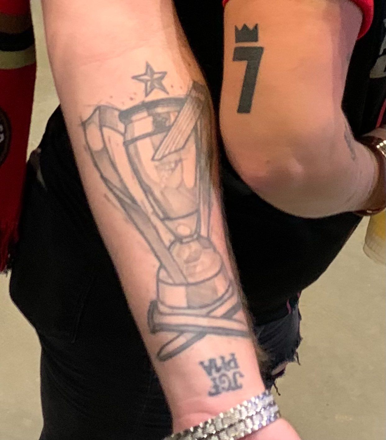Two arms with Atlanta United-inspired tattoos