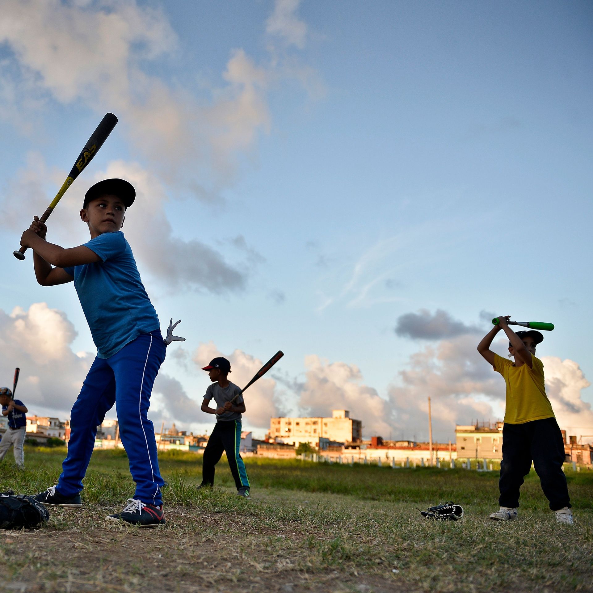 Cuban children practice baseball in a field of Havana, on September 17, 2018