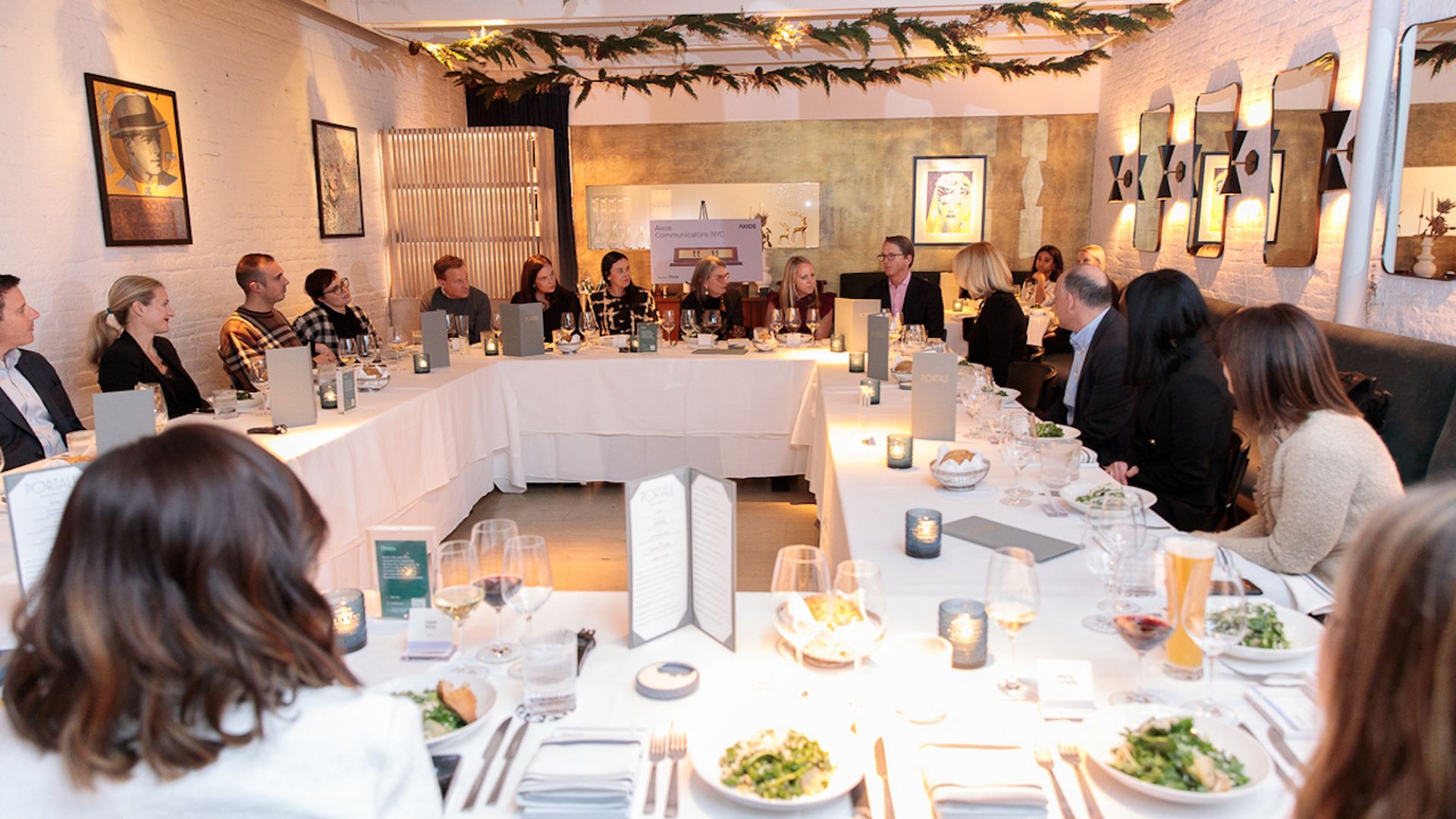 25 top communicators sitting around dinner table 