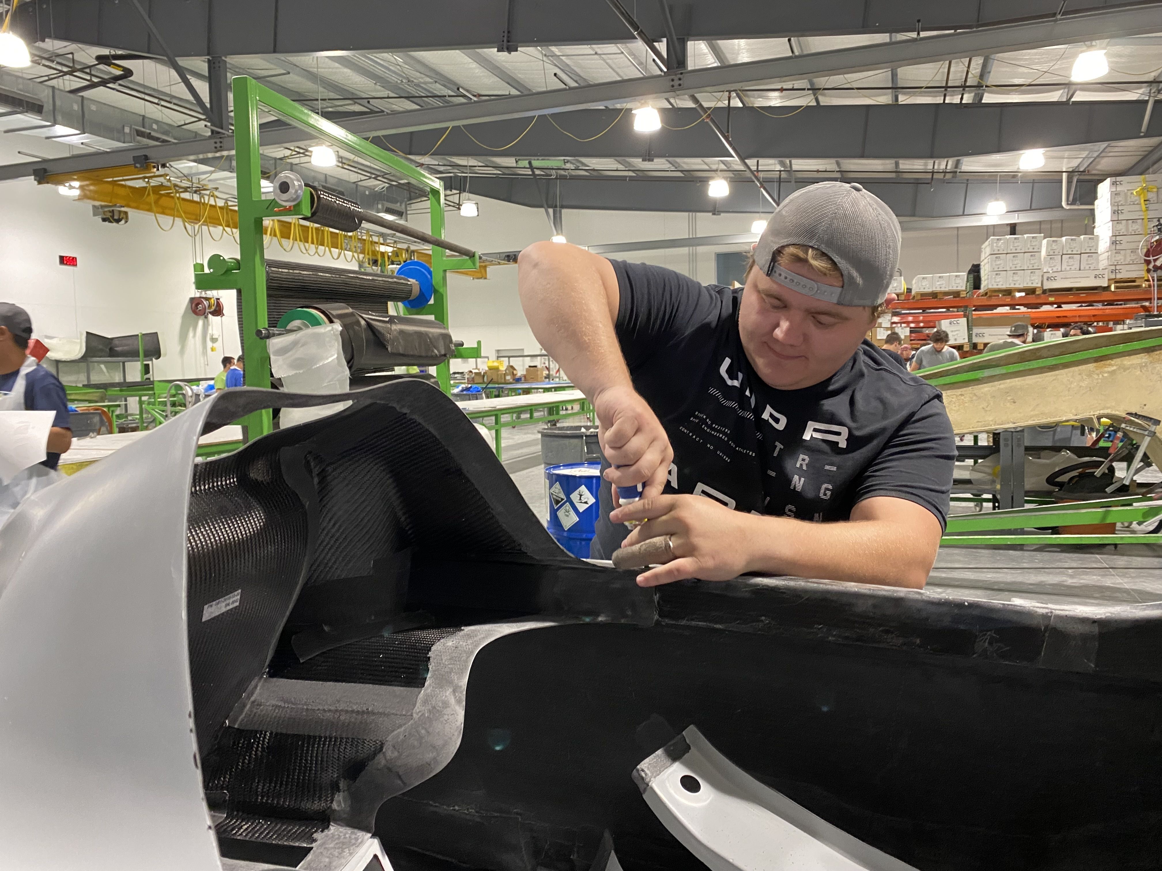 A worker assembles parts of a GameBird 1 fuselage. 