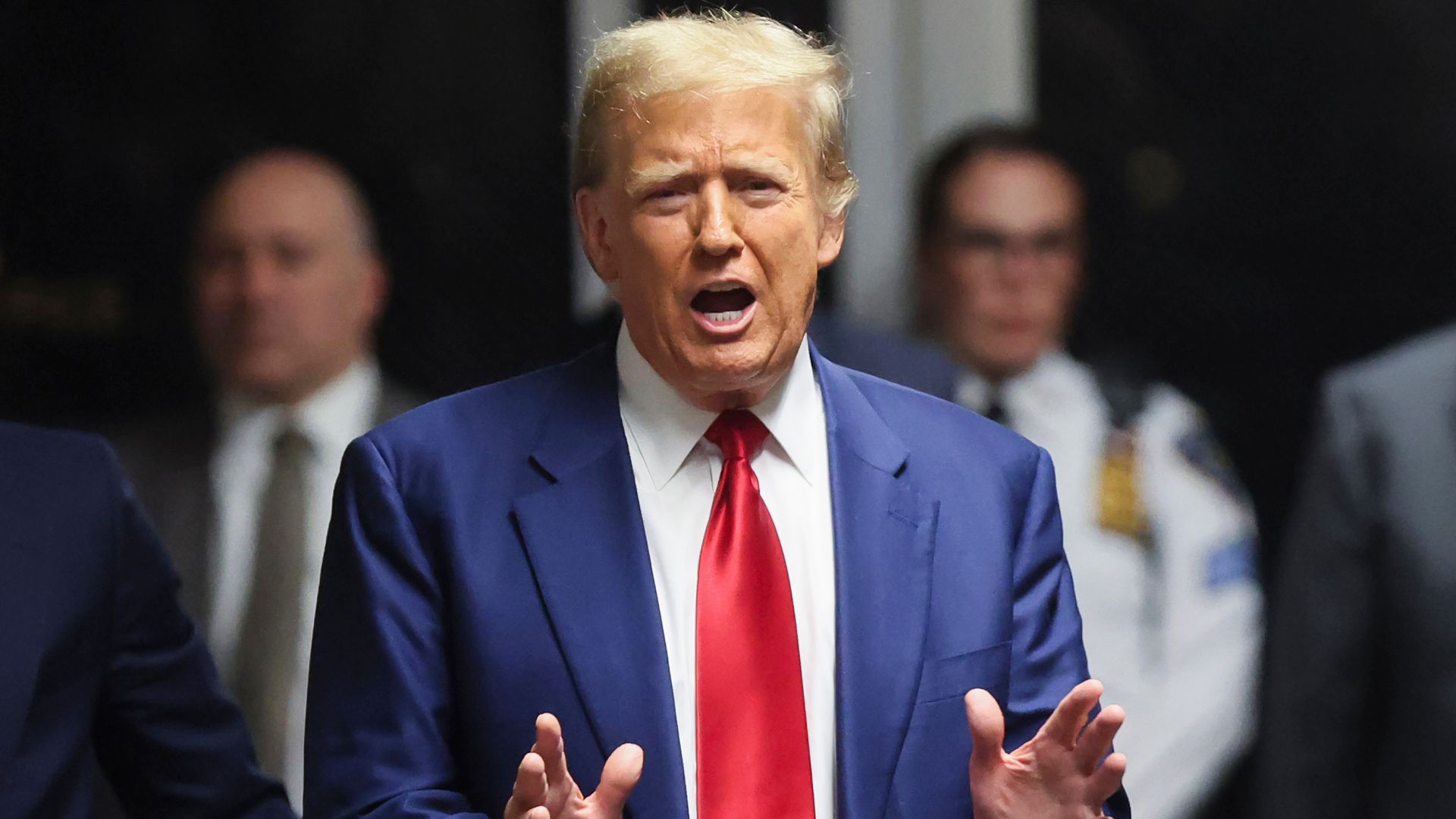 Donald Trump gestures to a camera.