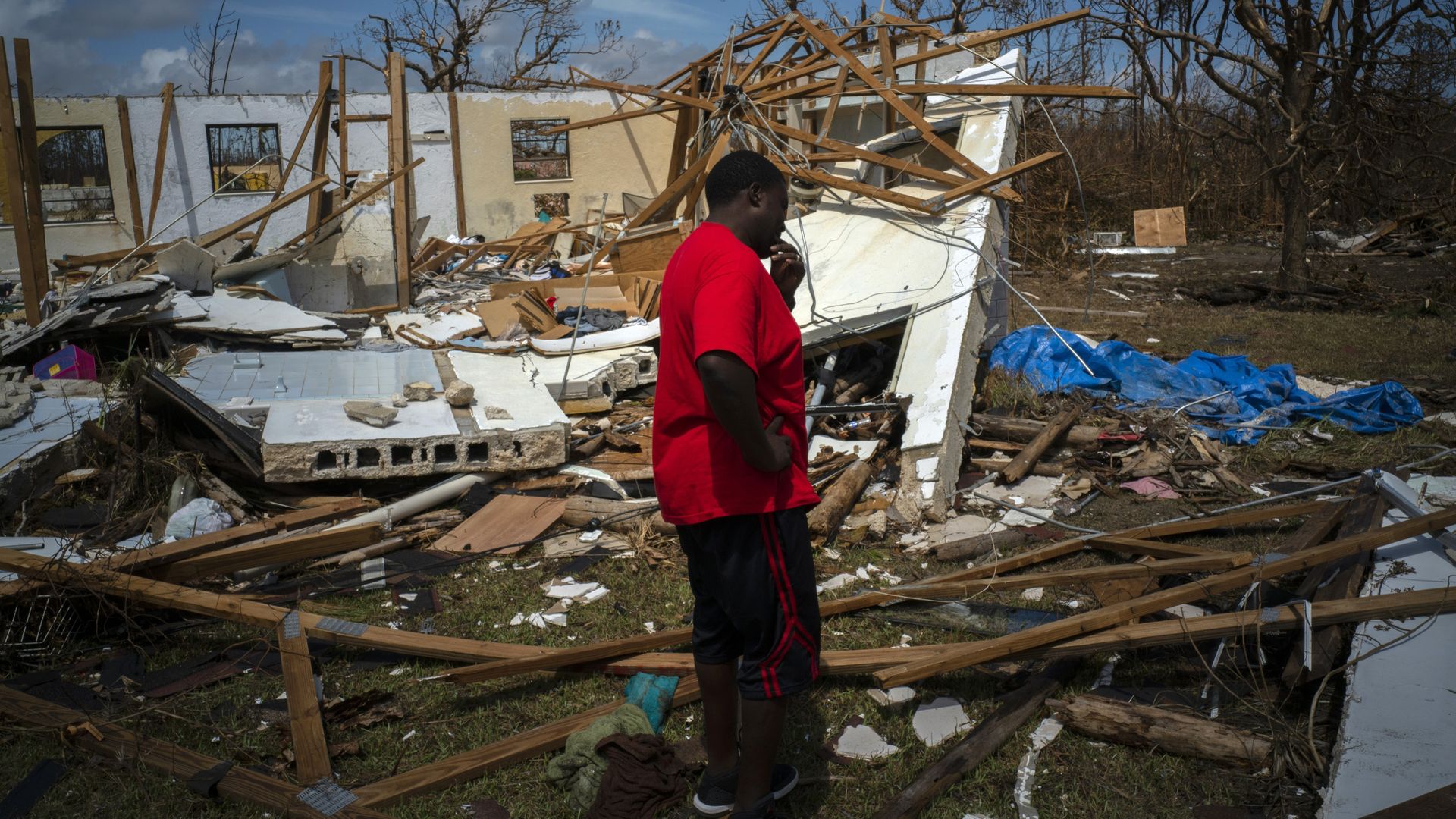 A man cries at the sight of his destroyed house in the Bahamas