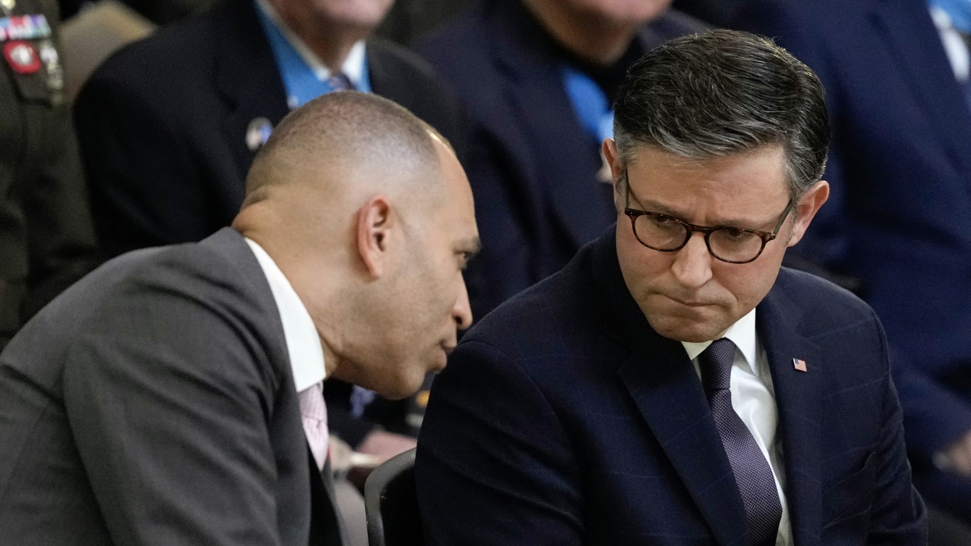House Minority Leader Hakeem Jeffries, wearing a gray suit, and House Speaker Mike Johnson, wearing a blue suit.